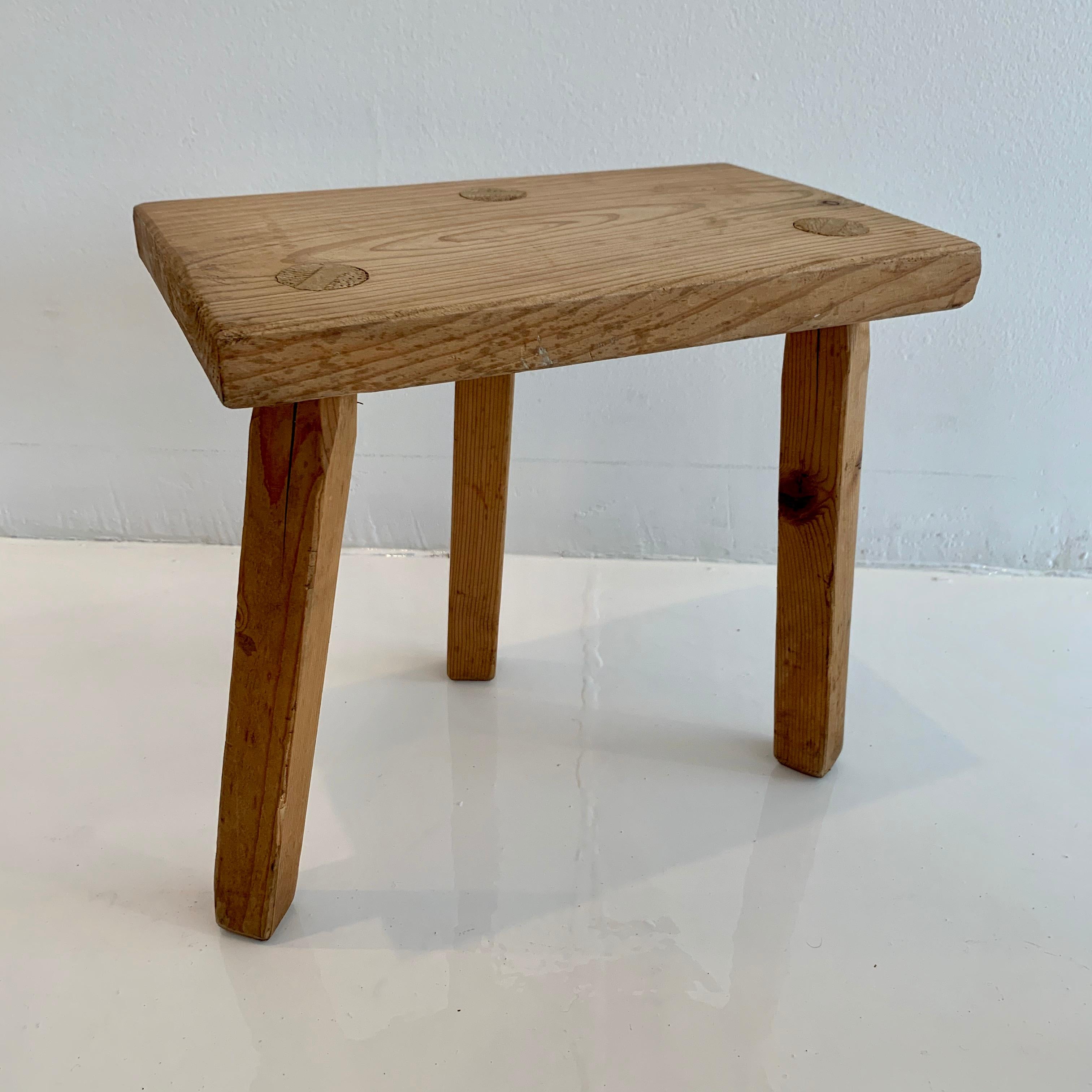 Vintage wooden milking stool made in France, circa 1950s. Thick seat with tripod legs. No nails or hardware. Great lines and shape. Rustic petite stool with a ton of presence. 
 