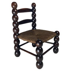Wood turned bobbin low rush chair in the style of Charles Dudouyt, France, 1950s