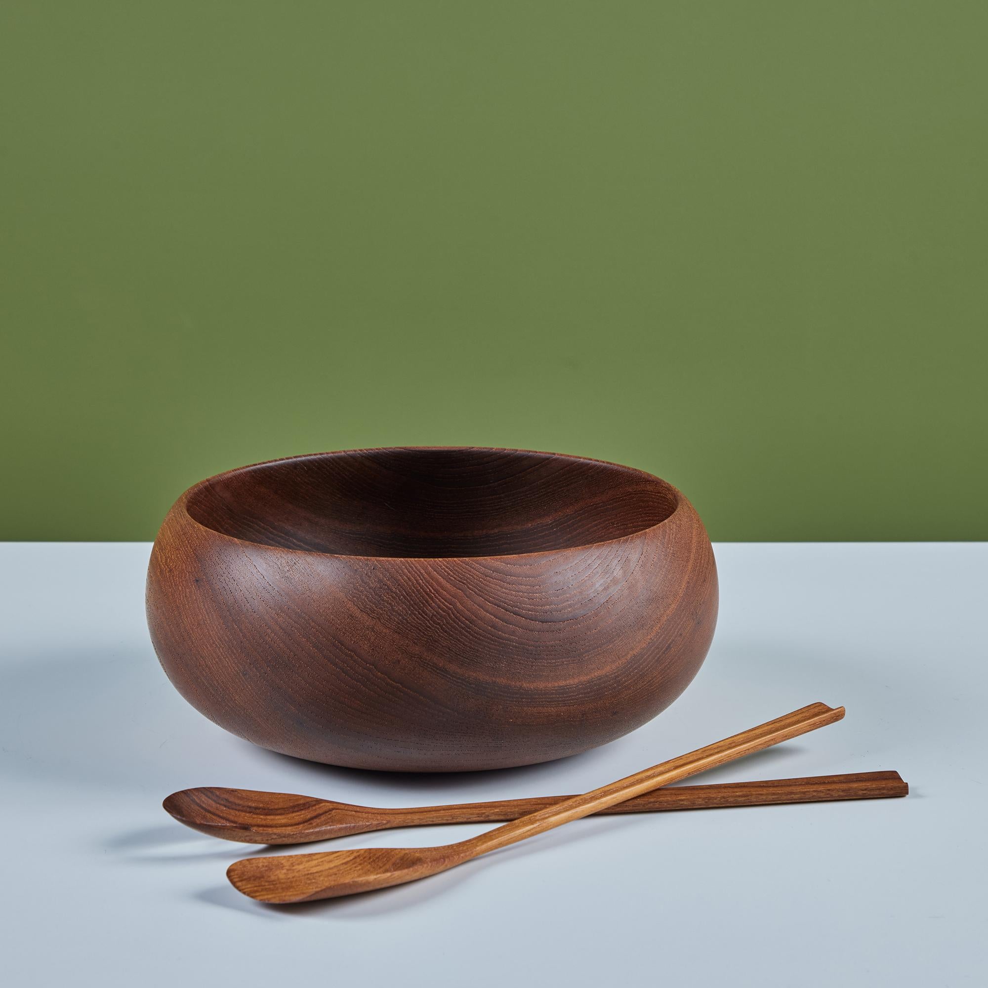 Teak wood turned bowl with utensils. This vintage piece has been exceptionally maintained, as the teak has aged to perfection.

Dimensions
Bowl: 11.25