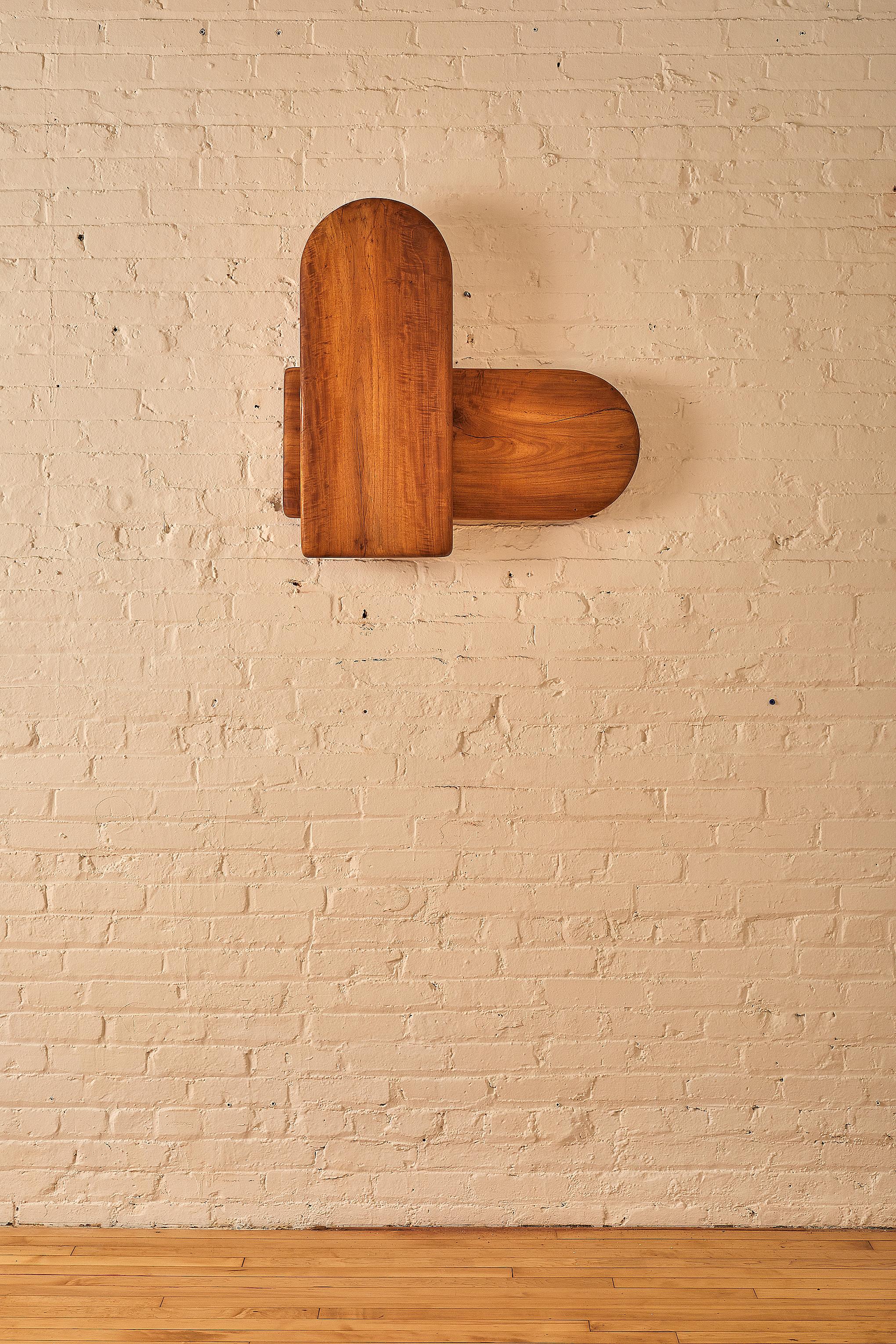 This wood wall sculpture designed by The Somerset House was made in house and adds a warm sculptural element to any room.

