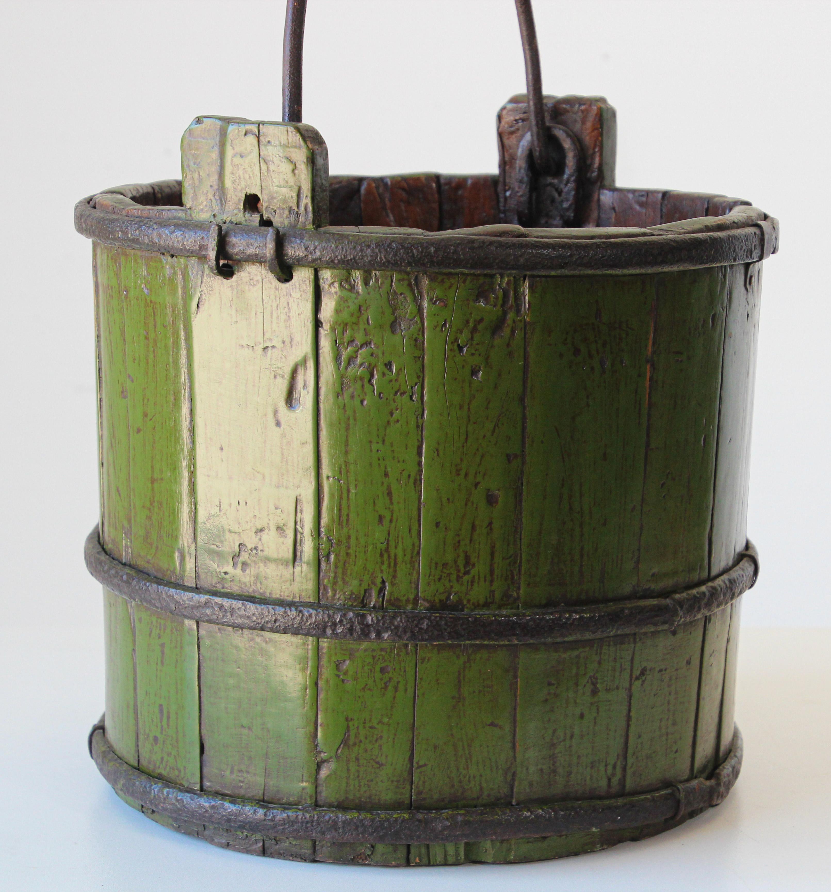 Antique Asian Chinese wood water bucket with wrought iron bands.
Early handmade water well wood with hand forged iron bands and handle.
A classically shaped antique Chinese wood water bucket with original cast iron handles and straps with lovely