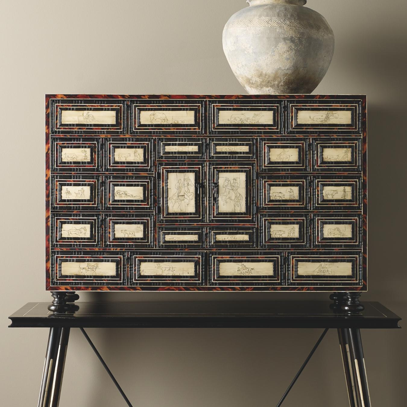 This stunning cabinet is influenced by XVIIIth century furniture with a more contemporary base, it has sgraffito bullfighting motifs and has bone and faux tortoiseshell inlays.
  