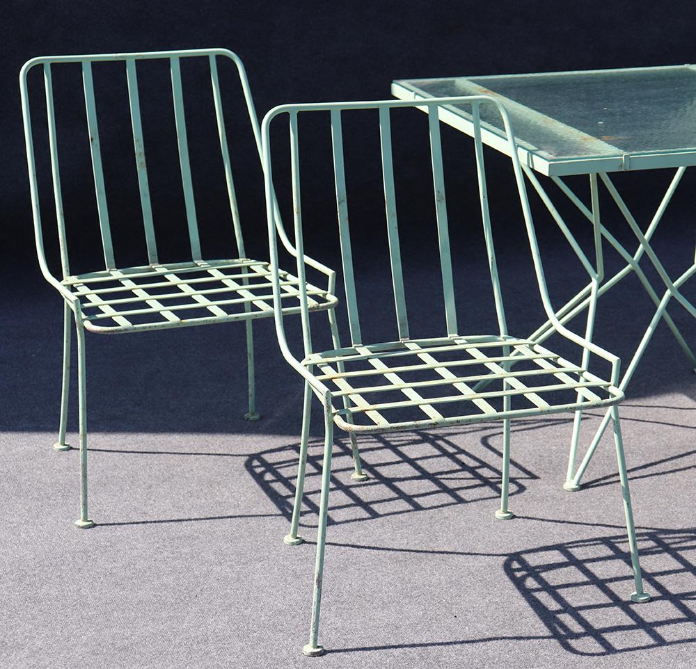 This is a very rare Woodard of Michigan patio set in the original 1950s turquoise finish. The table has it's original wavy glass and the chairs are only in need of cushions to be used right away. The table measures: 29