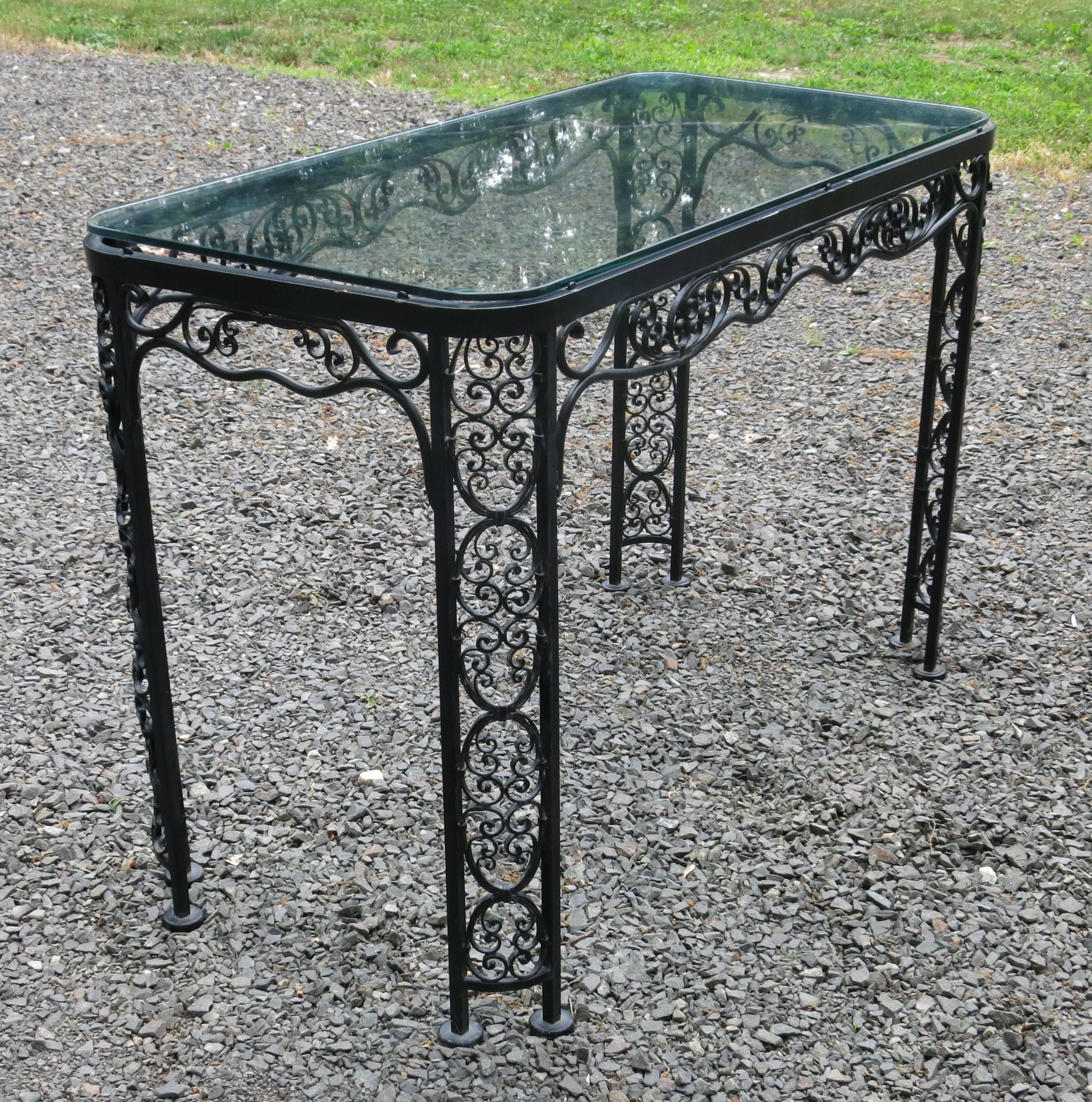 Woodard Andalusian pattern patio table. Table has a few chips to the paint, and glass has a few scratches and a chip to one corner. Complimentary piece to the white dining set that is listed. Rare to find. It is 20.5