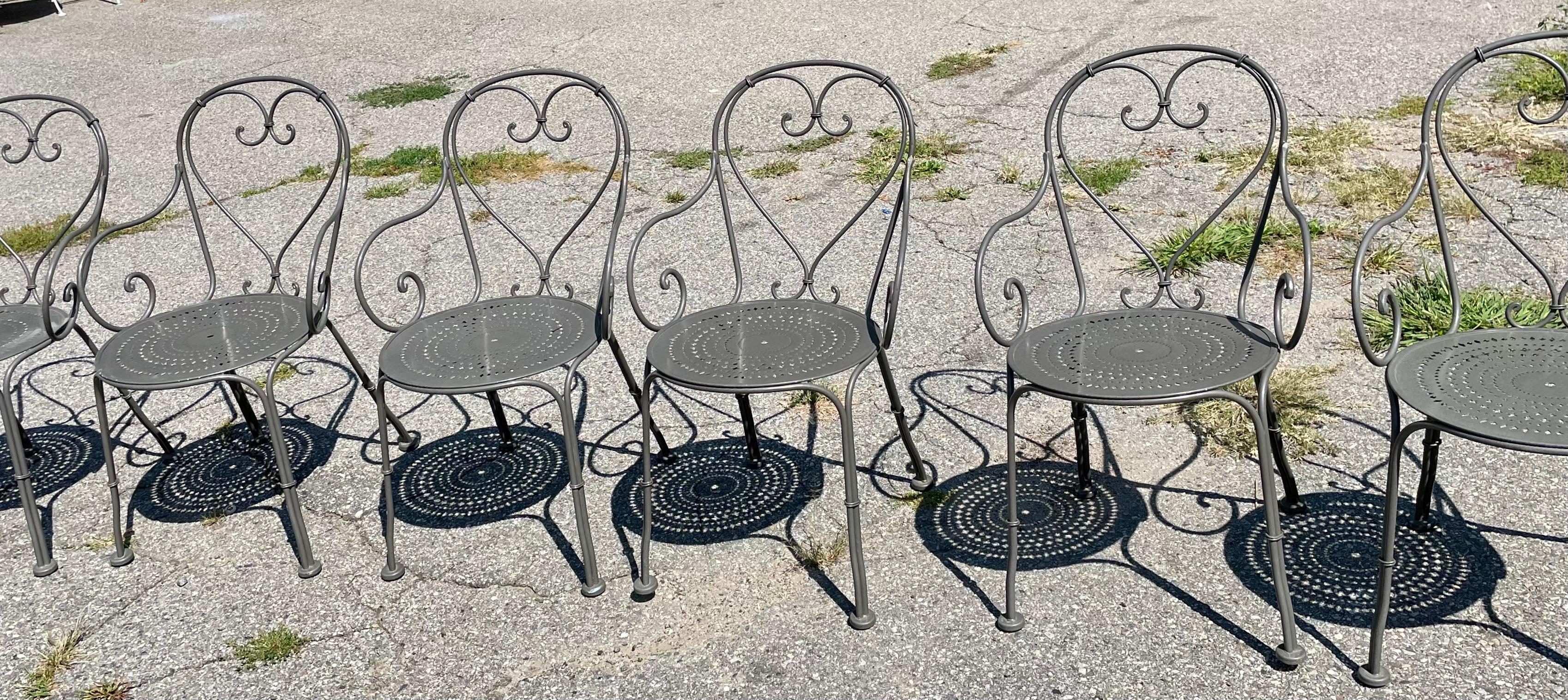 Woodard Chairs A Set of 10

French Cafe Chairs made out of heavy duty wrought iron are available now and ready to ship for your immediate enjoyment. These chairs feature a Heart Shaped back with scrolling arms and a generous seat diameter. Filagree
