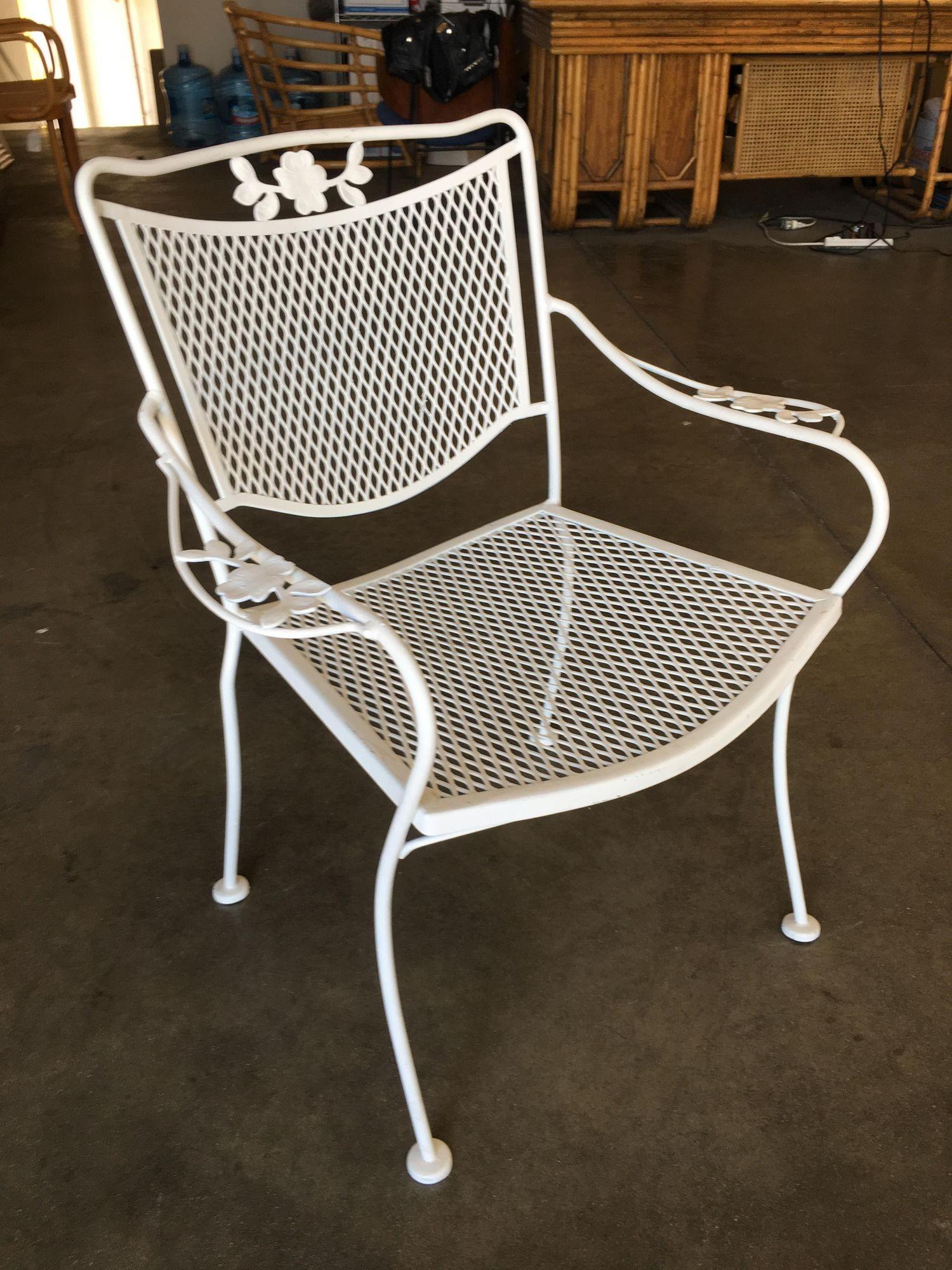 Set of four Russell Woodard designed wireframe outdoor patio chairs with leaf pattern arms and mesh steel seats. More are available upon request. All outdoor furniture can be repainted in the color of the buyers choice at no extra charge.