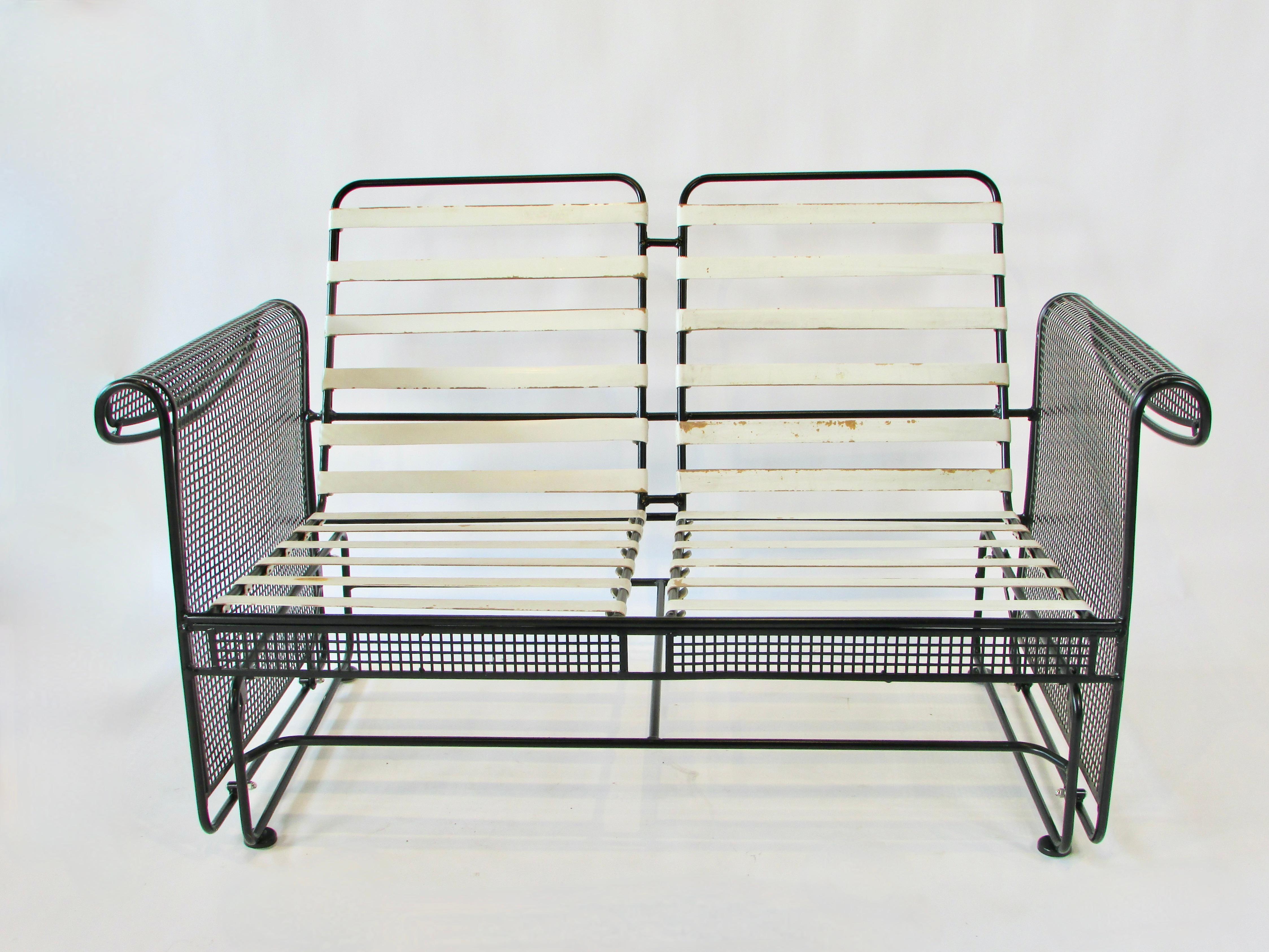 Woodard two piece  porch glider .  Recently powder coated in matte black finish . New glides added to feet . Wrought iron seat frame with mesh steel sides mounted to solid wrought iron frame  using four steel straps with ball bearing fittings .
