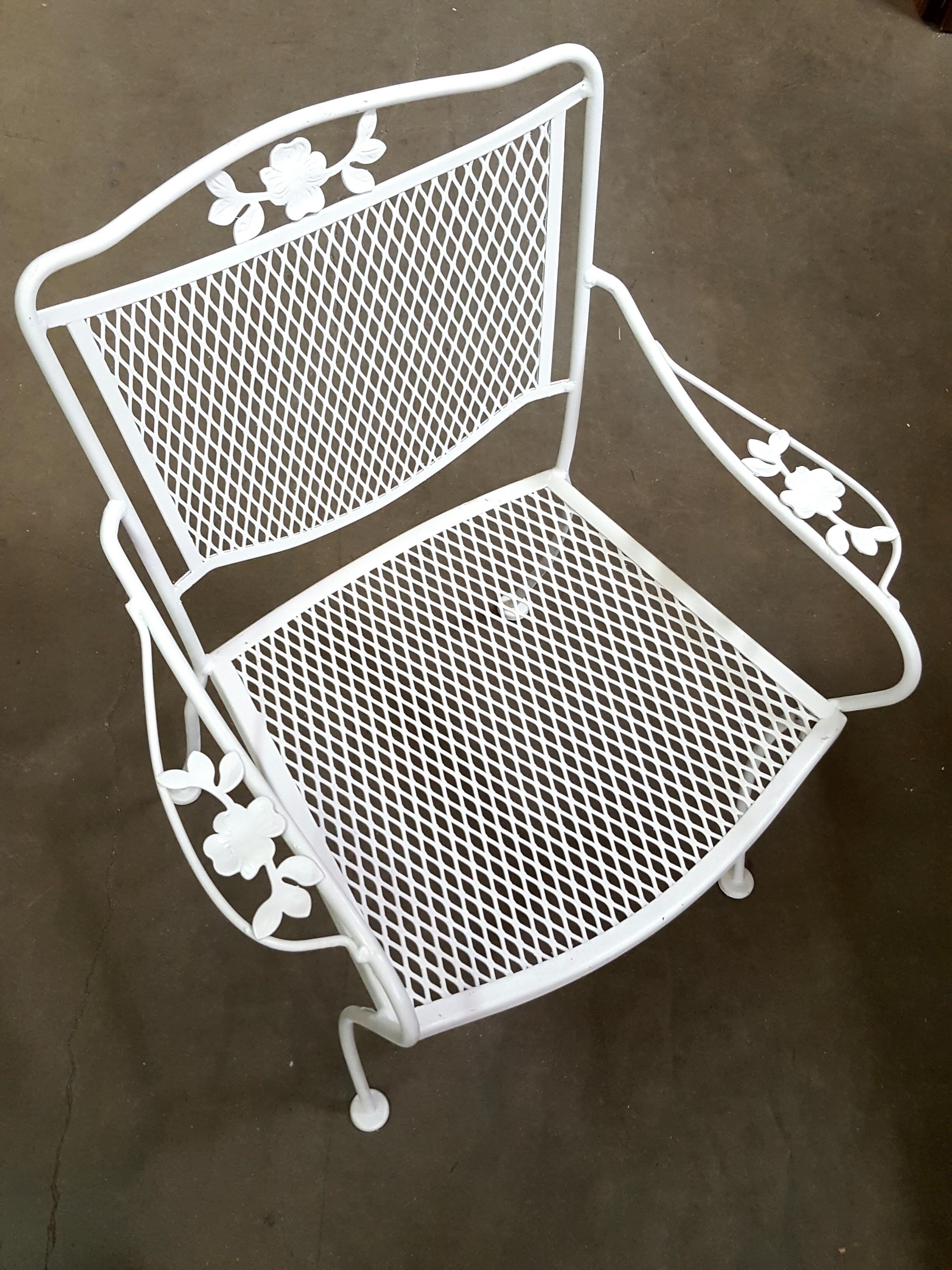Vintage outdoor mesh armchairs with a decorative scrolling floral motif along the backrest.
8 available.