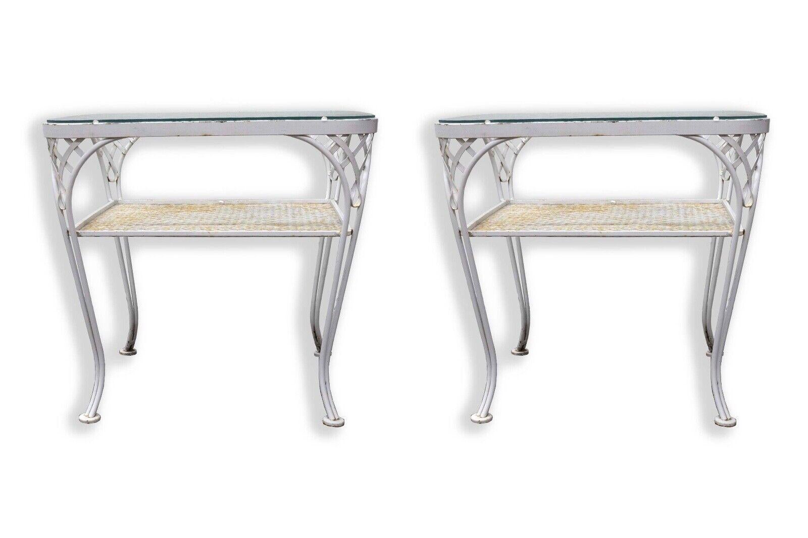 This pair of Woodard Two-Tier White Wrought Iron Patio Tables epitomizes the quintessential mid-century modern outdoor aesthetic. Crafted with precision and attention to detail, these tables feature a striking two-tier design, providing both style
