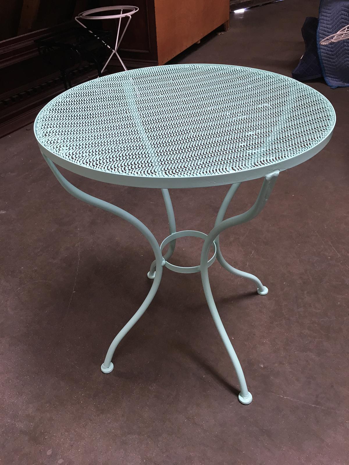 Vintage round outdoor/patio side table with iron scrolling base and steel mesh top by the Woodward company. The table can be repainted in your choice of color, circa 1950 by Woodard.