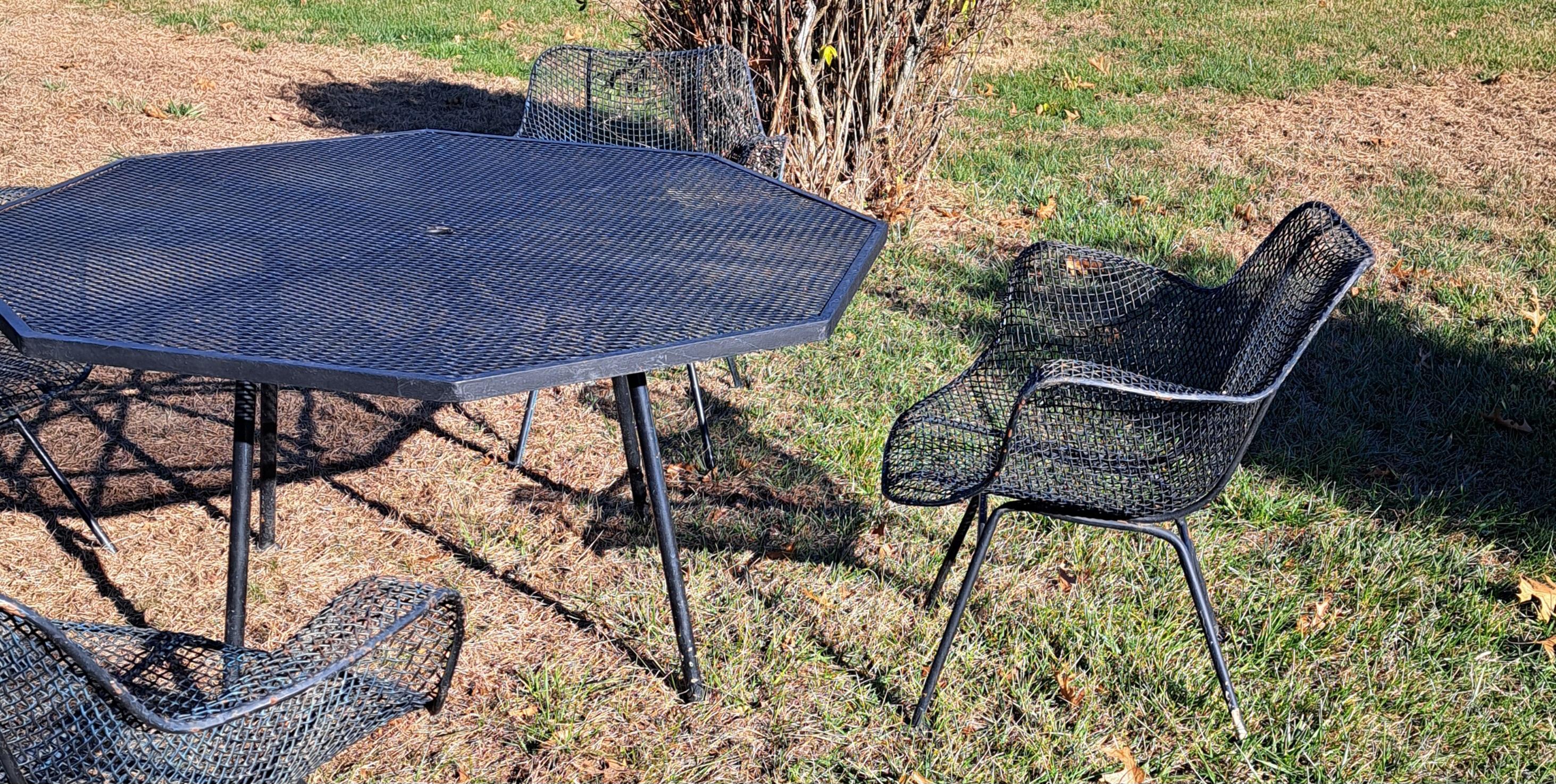 Woodard Sculptura Dining Set consisting of a table and 4 chairs.  Table is octagonal and is 52