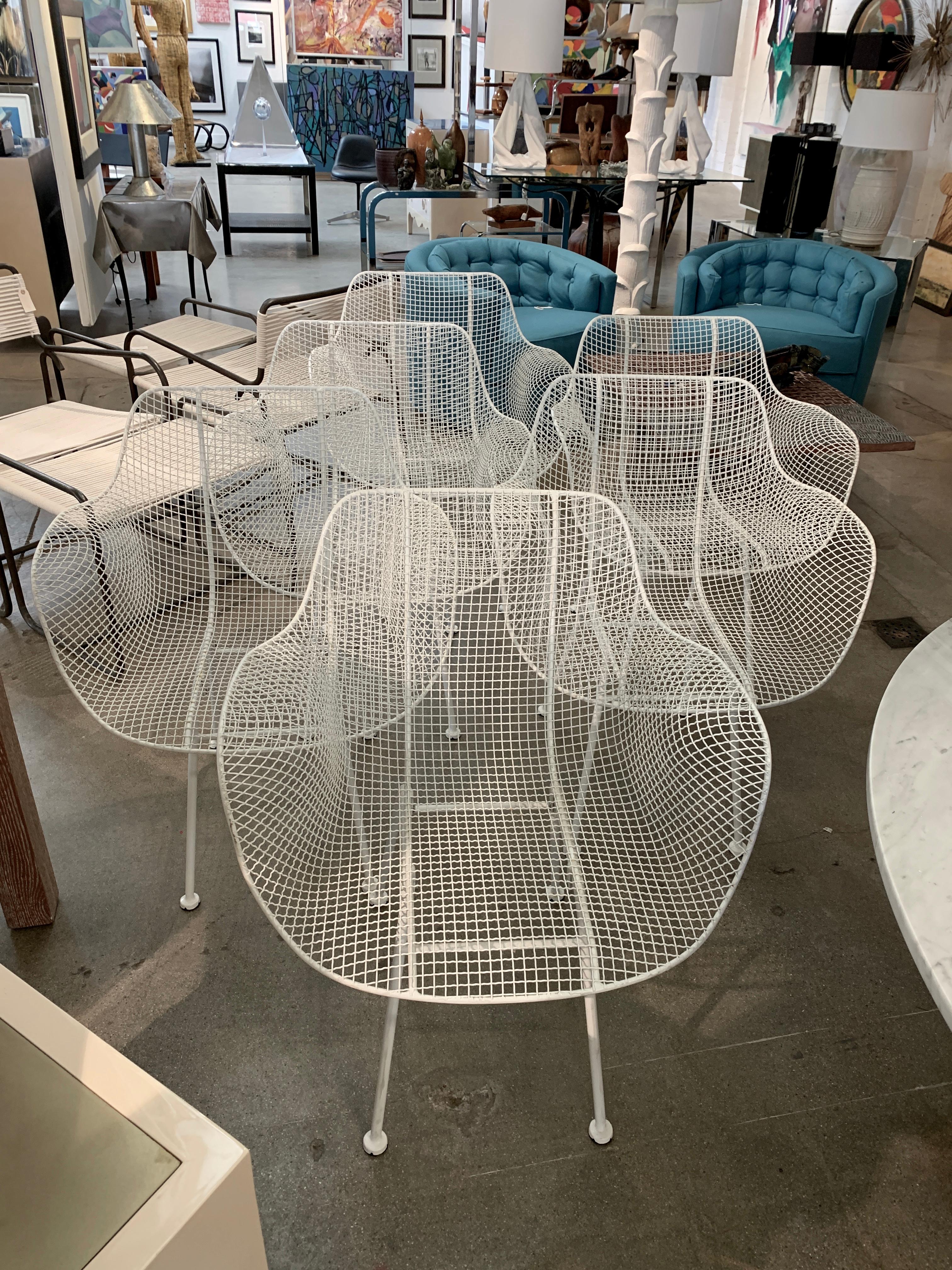 A set of six Woodard Sculptura occasional chairs in powder coated white iron. These are Classic Sculptura chairs that can be used for dining or lounge. Seat height is approx 16-17 inches depending on the area measured. There are some minor areas of