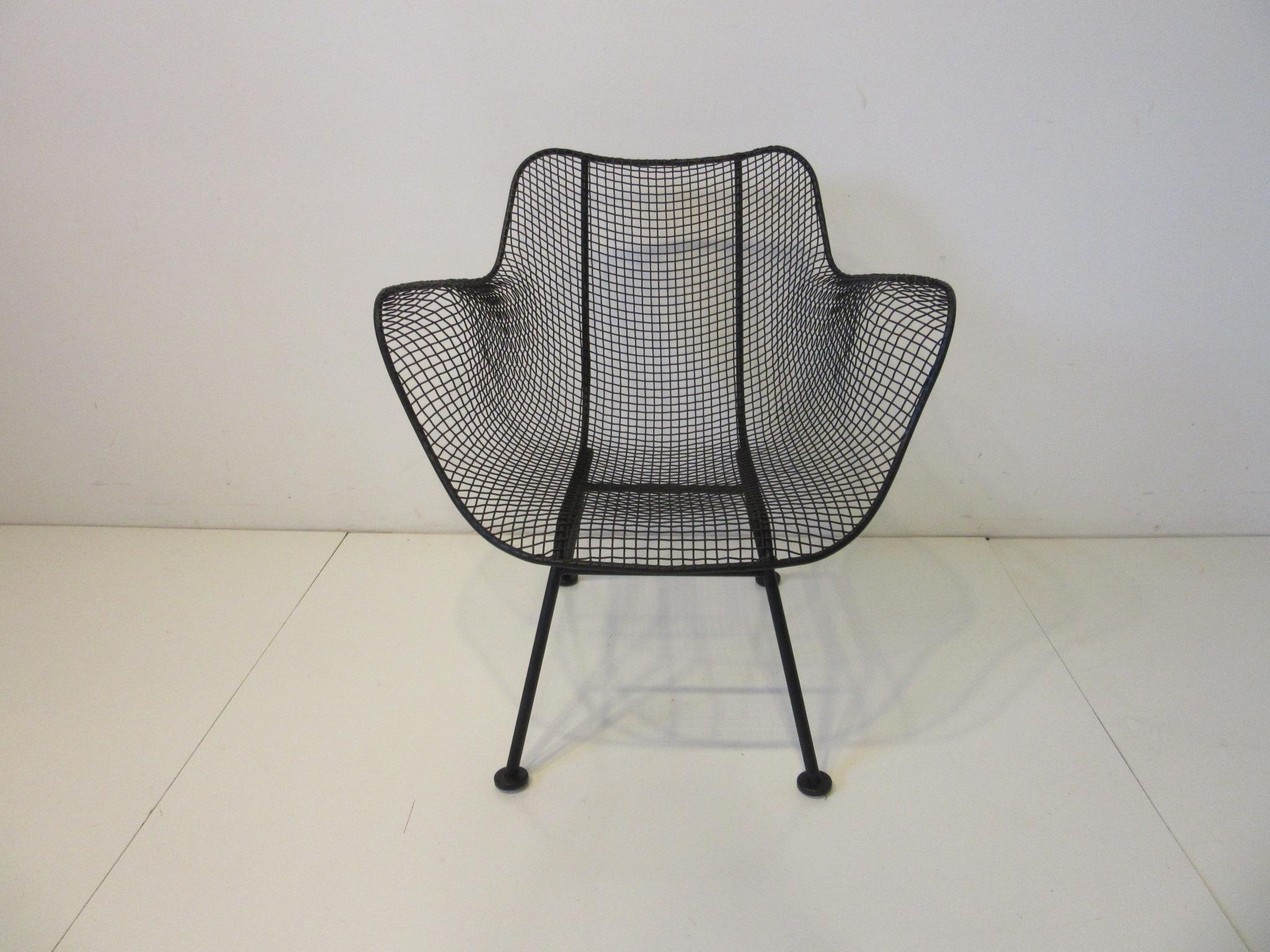 A pair of molded wire mesh armchairs in a satin black finish, the chairs are in the lower lounge height for comfort. The pair have been professionally restored dipped, primed and painted for the next owner to enjoy indoors, outdoors or a three
