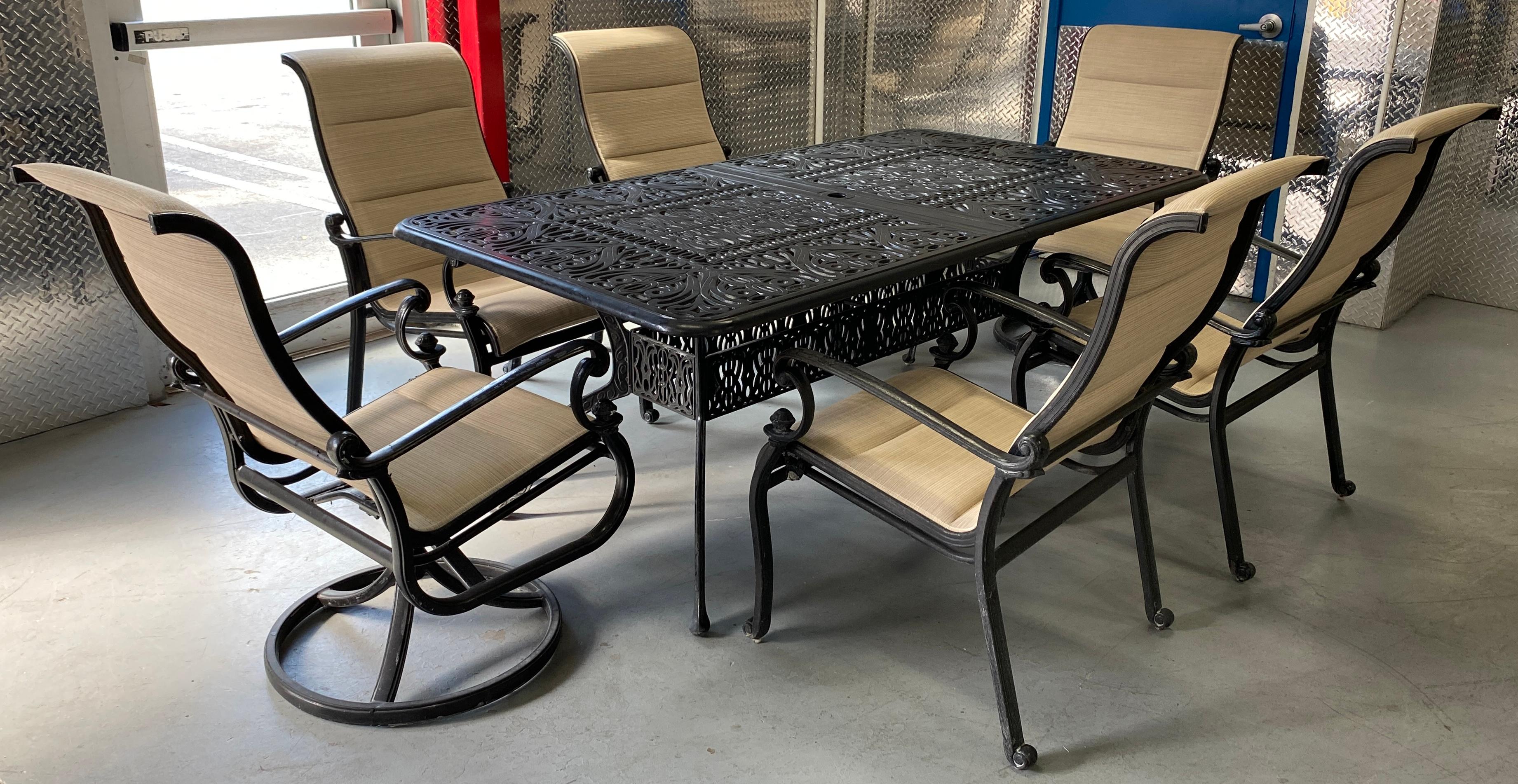 A lovely vintage Garden Dining Set in the Russell Woodard Style. The entire set is made of practical cast aluminum includes an extendable dining table, 6 armchairs, 2 lounge chairs and an accent table. 

The intricately detailed extendable outdoor