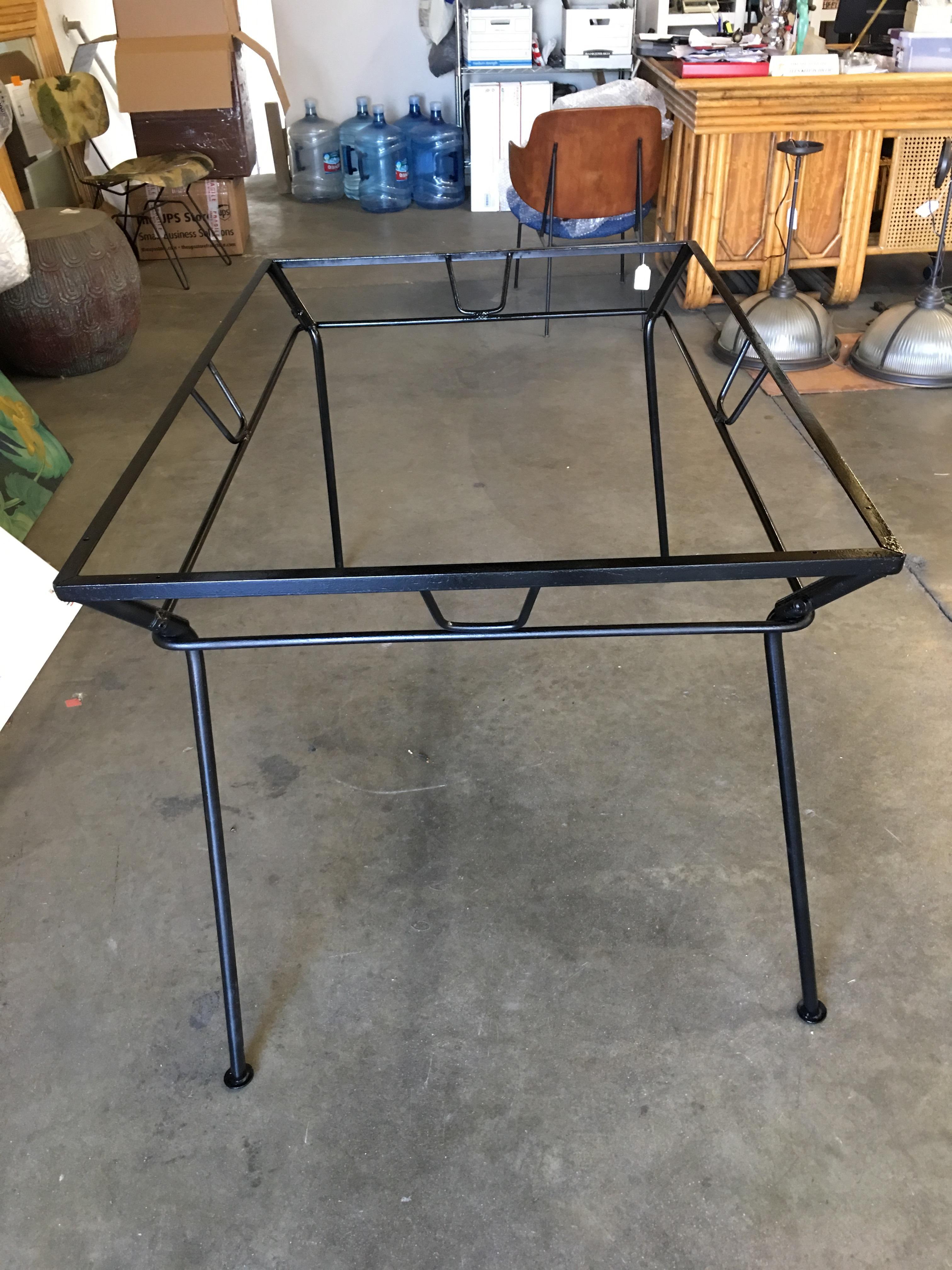 Woodard Art Deco glass and iron outdoor/patio table with a distinct art modernist style. This table is constructed with solid iron core rods and is finished in your choice of a pure white or black finish.