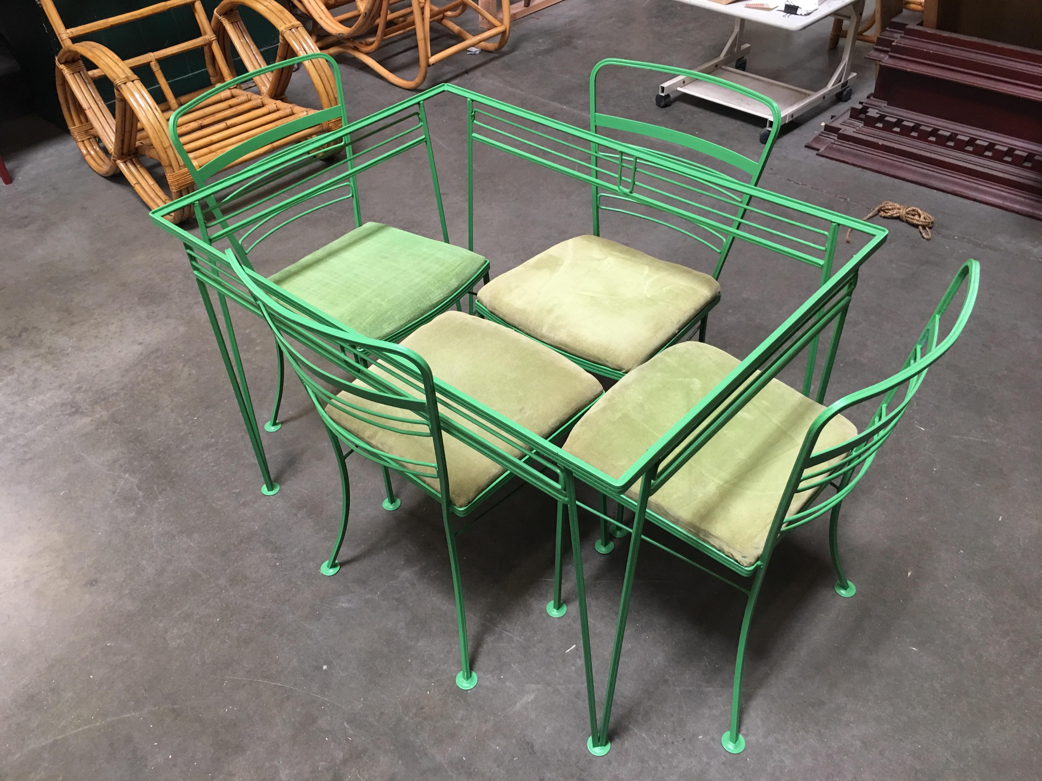 Woodard wrought iron Art Deco patio/outdoor set featuring four side chairs and one glass top dining table. This set is current repainted in green but be changed to your color of choice, included in the price. Measurements: Chairs H 33 in. x W 18 in.