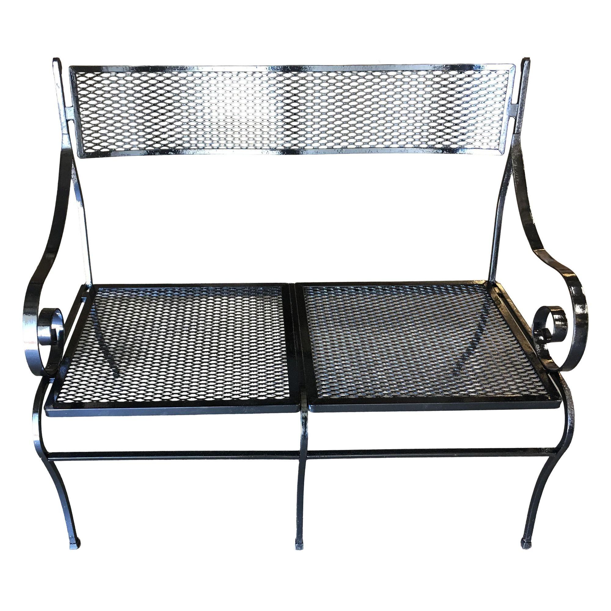 Mesh wrought iron outdoor garden loveseat bench with scrolling arms by the Woodard Company, circa 1950 all outdoor furniture can be repainted in the color of the buyers choice at no extra charge.
