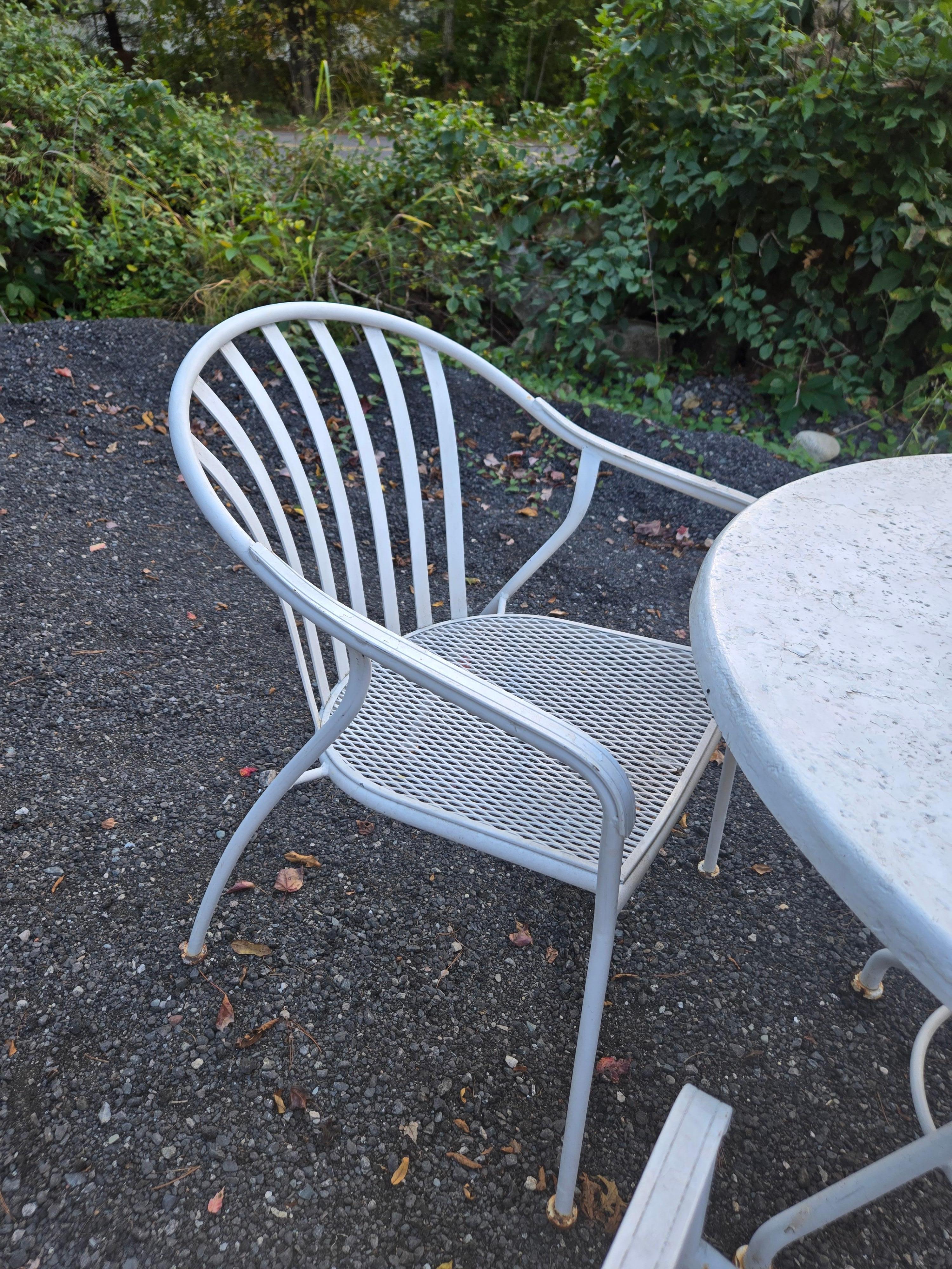 Vintage Woodard Wrought Iron Valencia Patio Chairs Set of 4 with FiberStone topped table and wrought iron base. Umbrella hole. Heavy duty and built to withstand all types of weather conditions. 

Shop Salterini Garden Furniture and Woodard Garden