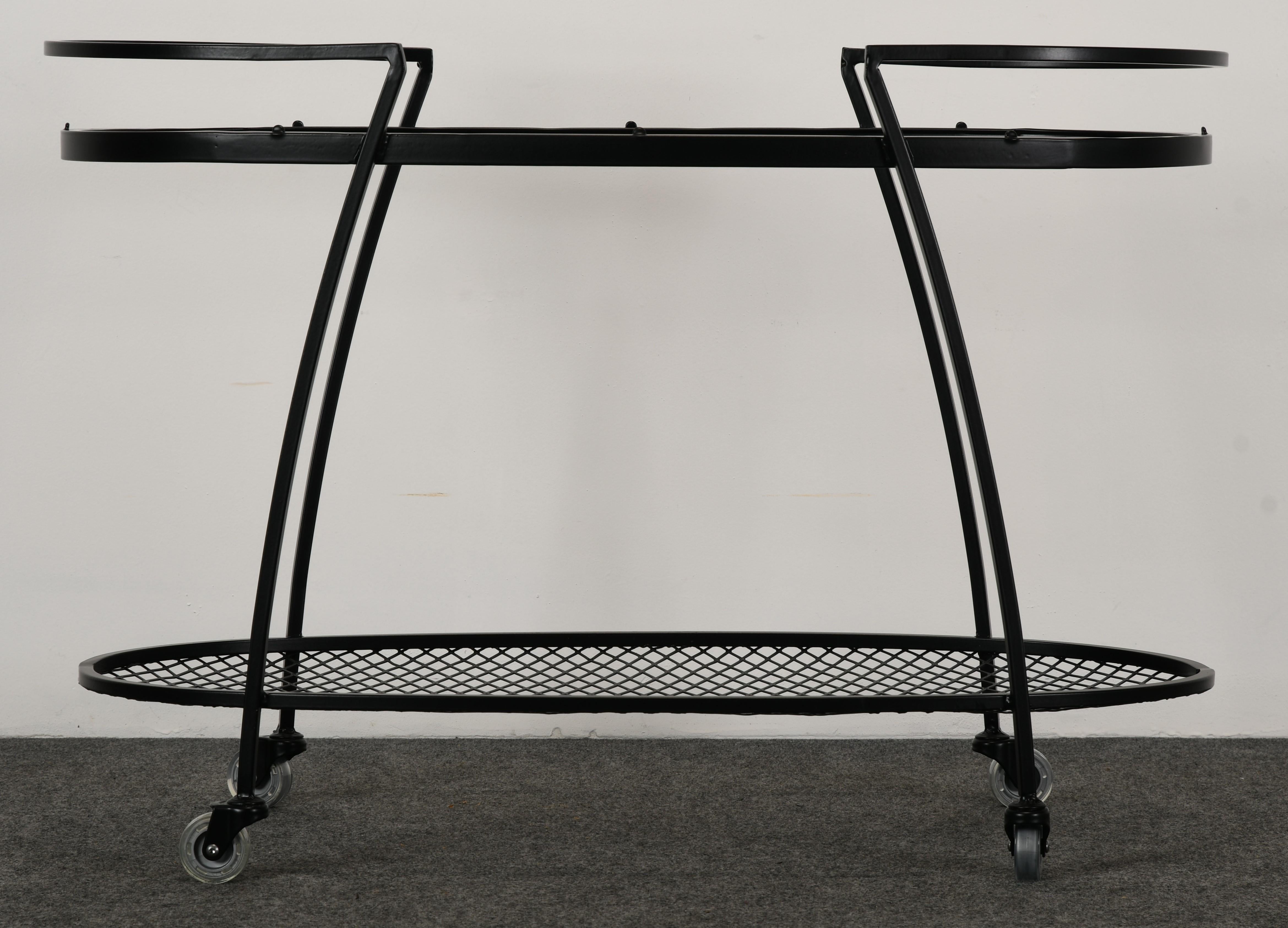 A wrought iron serving cart by Russell Woodard for Lee Woodard & Sons circa 1950. This stunning and modern design would work in any outdoor setting. The tea cart is newly powder-coated in black. Glass is vintage but in good condition. New wheels