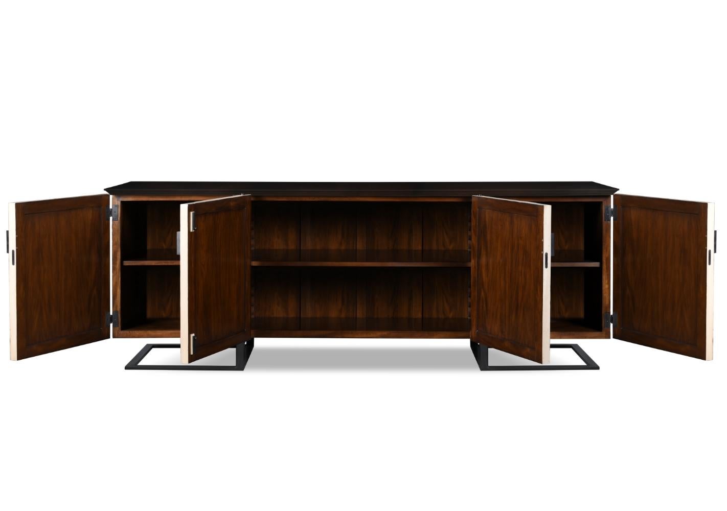 This piece is completely symmetrical with its four large doors decorated with wooden moldings that add texture to its front cover. The metal base holds up the wooden buffet, creating a harmonious contrast of both materials.