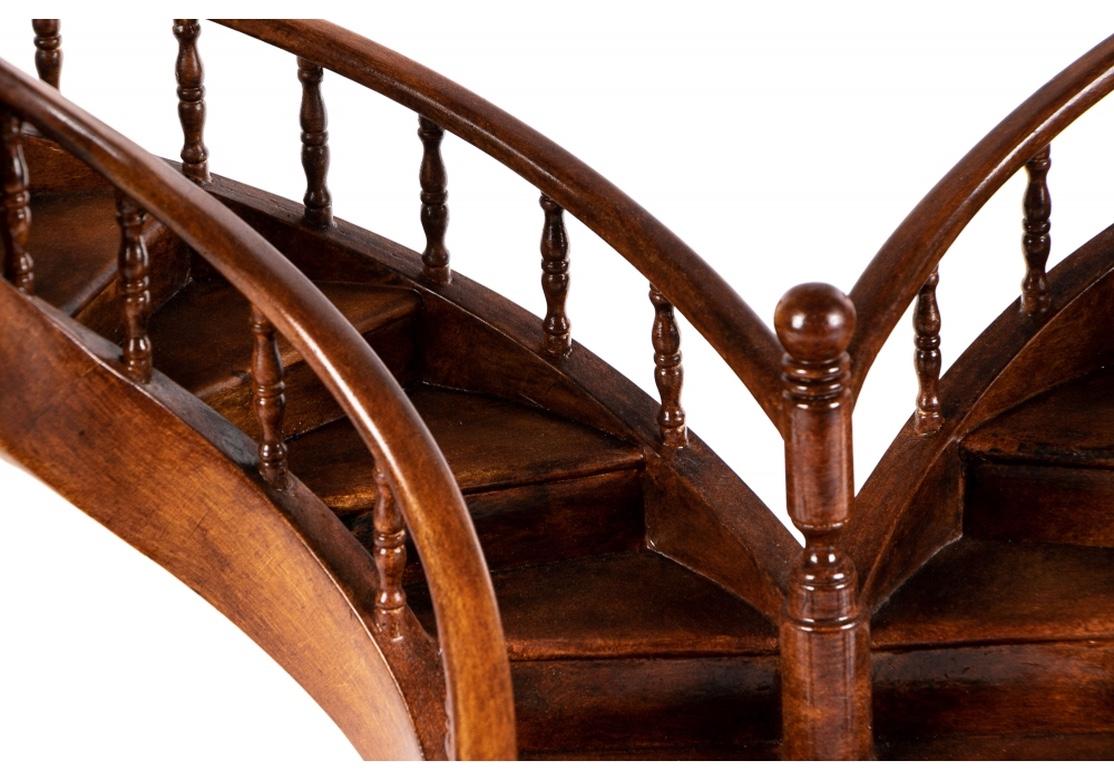 Fine Architectural model of a double spiral staircase. Honey stained wood with a tiered base. Four steps up to the double spiral staircase with turned supports. Open at the top. Ball newel posts. Very well made with fine attention to detail and