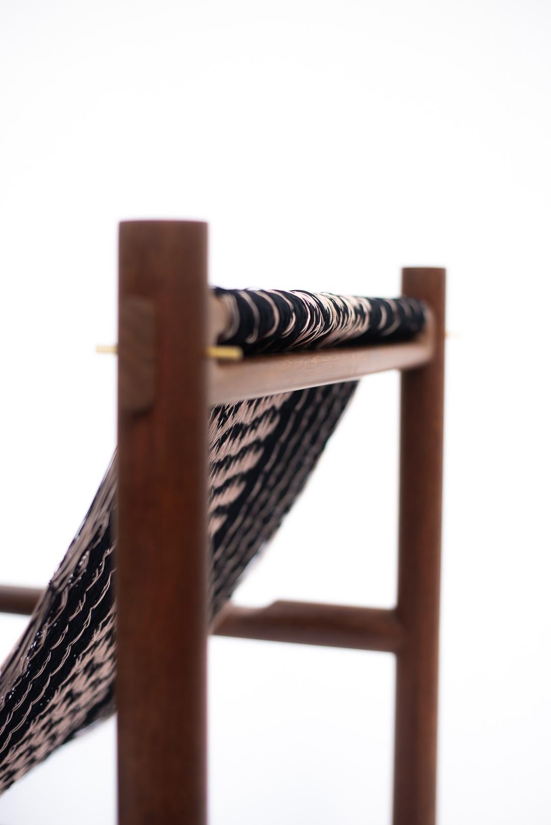 Turned Handcrafted Lounge Chair in Tropical Wood with Black & Pale Pink Woven Detailing For Sale