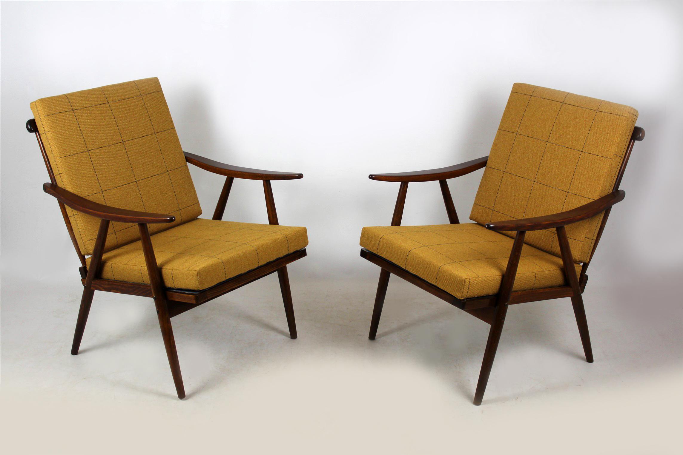 A pair of wooden armchairs from the mid-1970s. Made in former Czechoslovakia by TON (formerly known as Thonet). New double sided pillows, upholstered in checkered fabric.