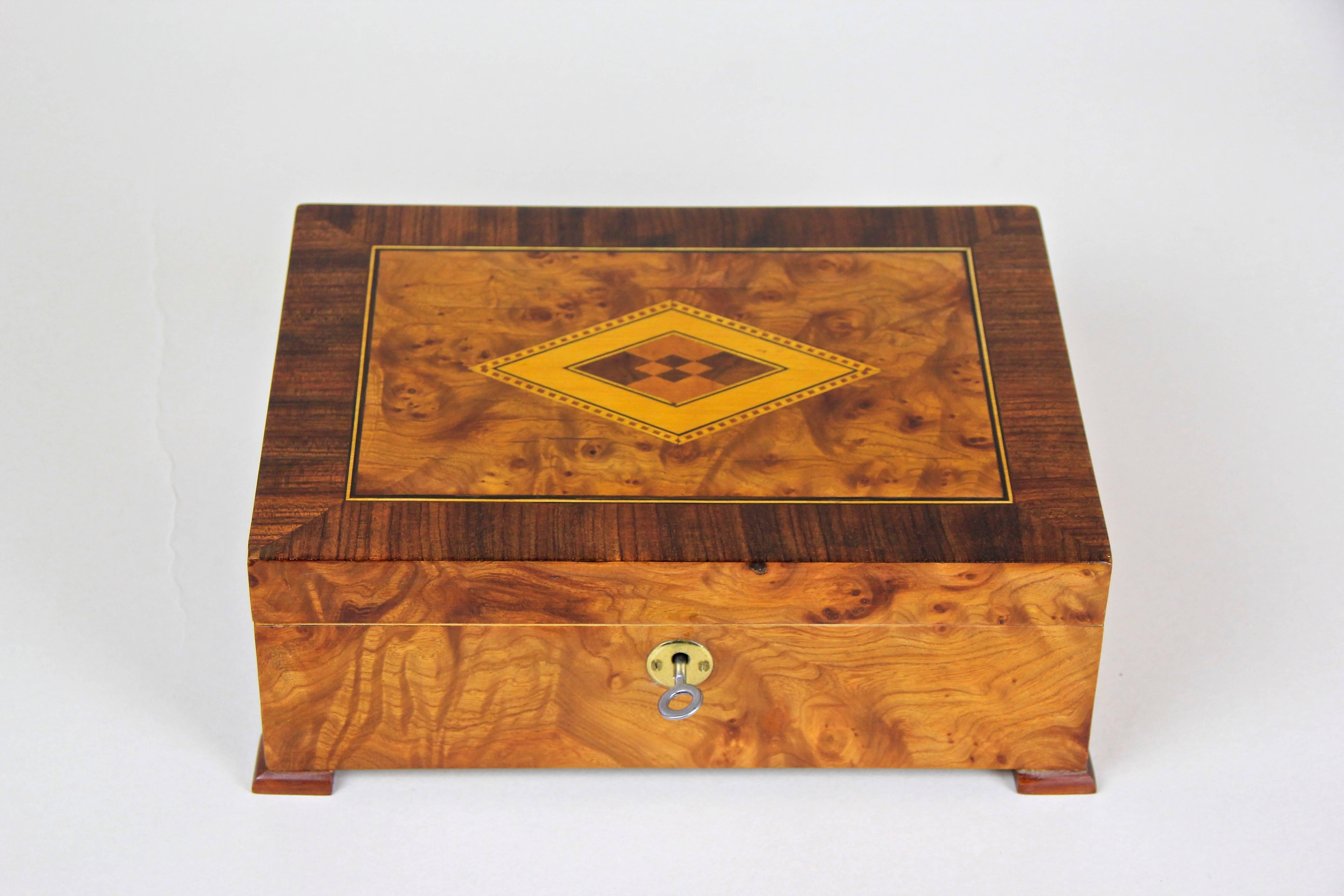 Precious wooden Art Deco box in fine bird's-eye maple with inlay work out of Austria, circa 1920. This highly decorative art deco box impresses not only with its beautiful grain but also with the elaborate inlay work on the lid, processed with