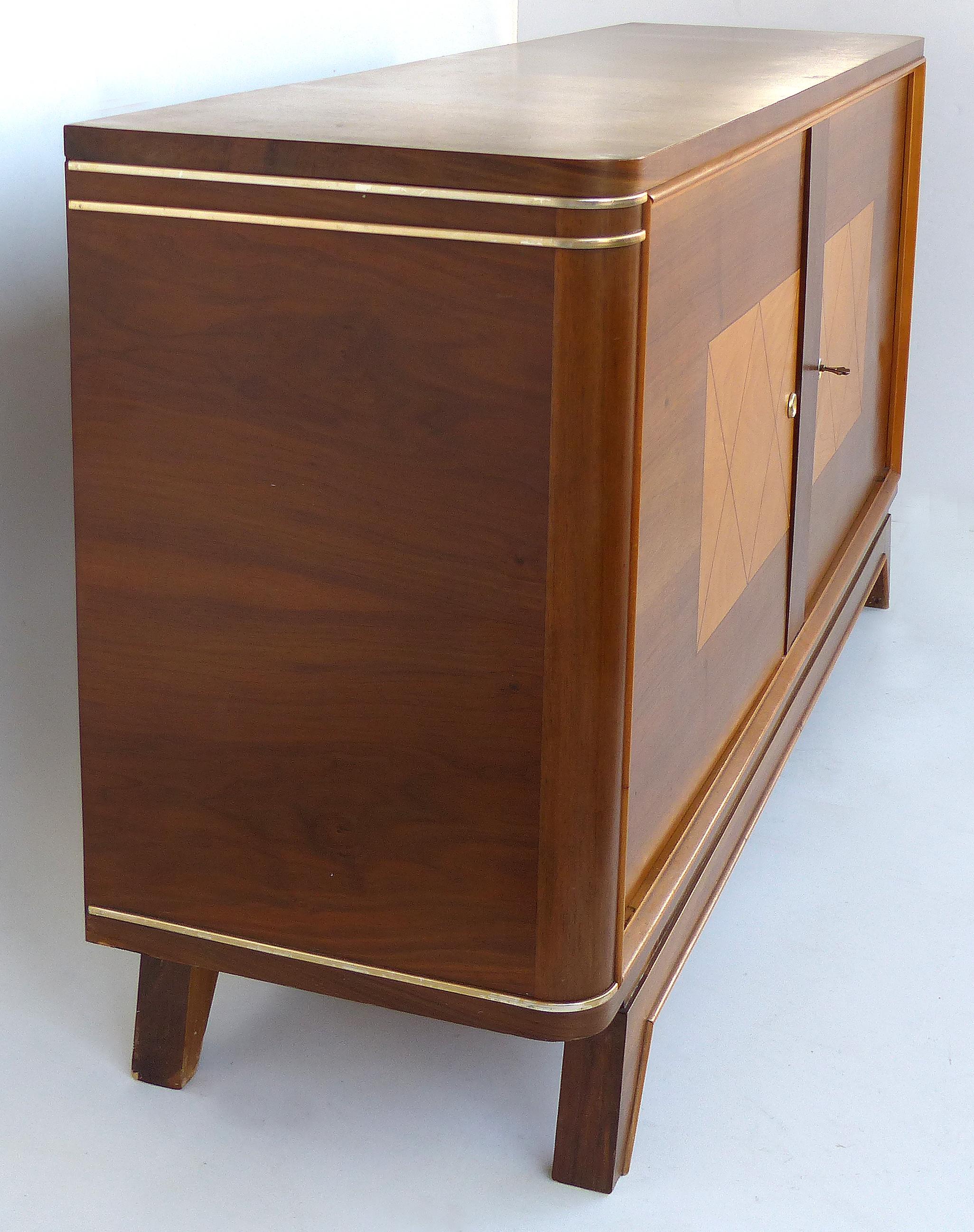 Wooden Art Deco Credenza with Two-Tone Pattern Doors

Offered for sale is an Art Deco two-tone wood credenza with two doors and splayed legs. The doors have an inlaid geometric designs with blonde bird's-eye maple interiors. These doors open to