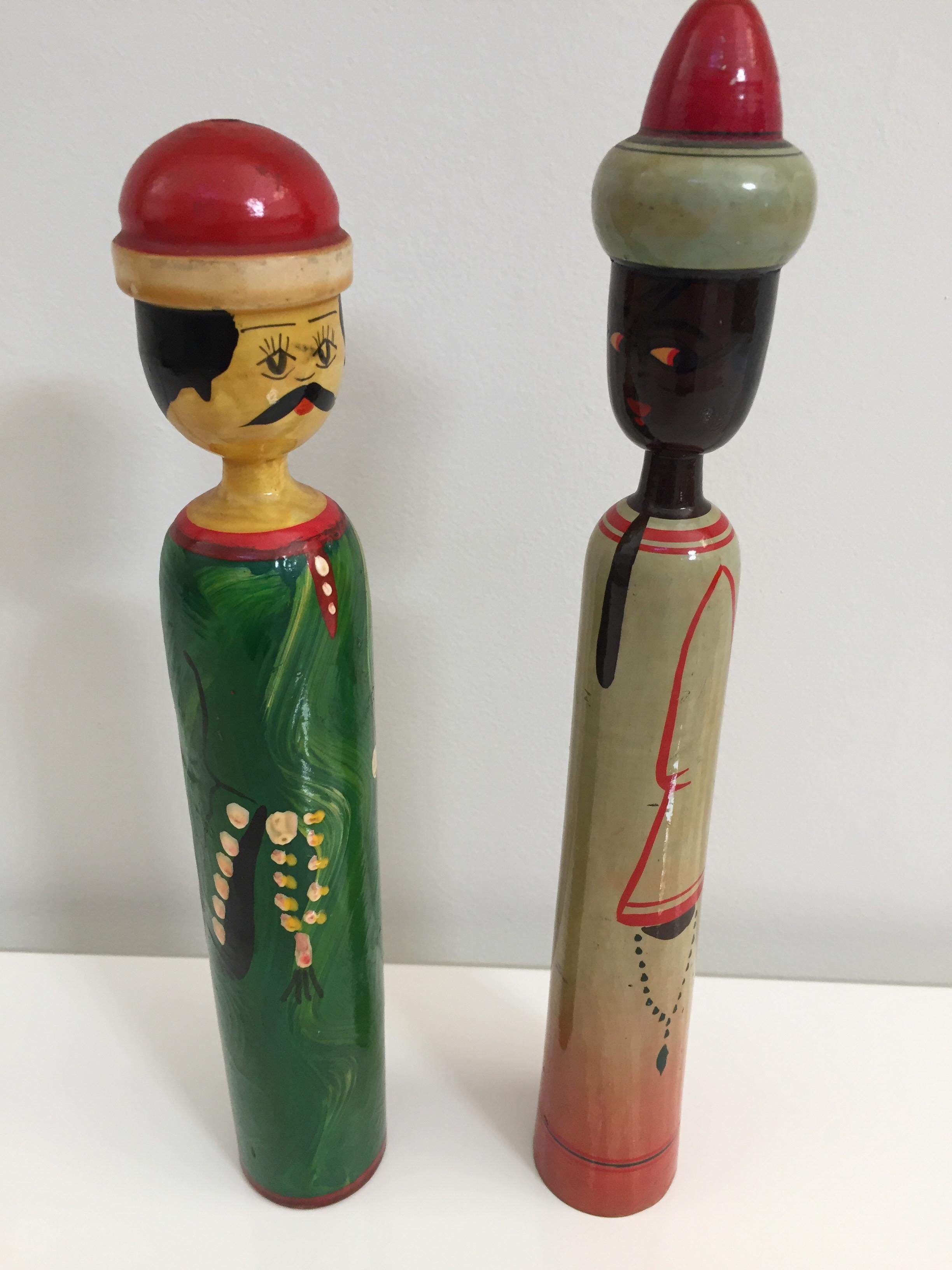 Wooden Artisanal middle eastern men dolls.
Set of two handcrafted and hand painted dolls, collectible toys of middle eastern Folk Art, men wearing traditional costumes and red hat.
