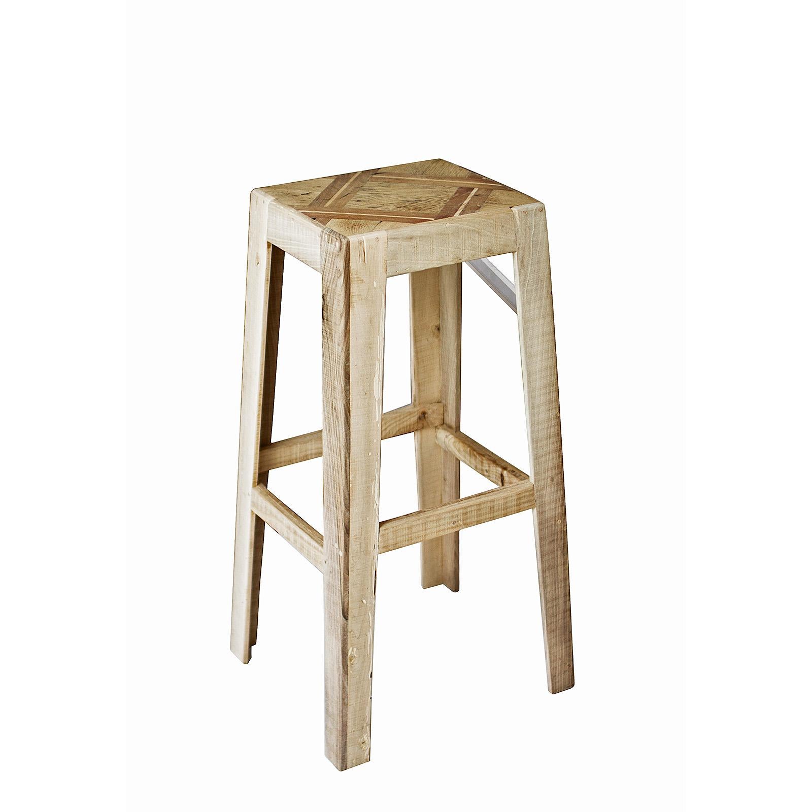 The bar stool is made of an antique piece of walnut wood floorboard, handcrafted Elmwood, and Plexiglass. The footrest heights are all different to accommodate all ages and heights. 

Materials: Nut and Elm Wood, Plexiglass and Screws of Brass. 
