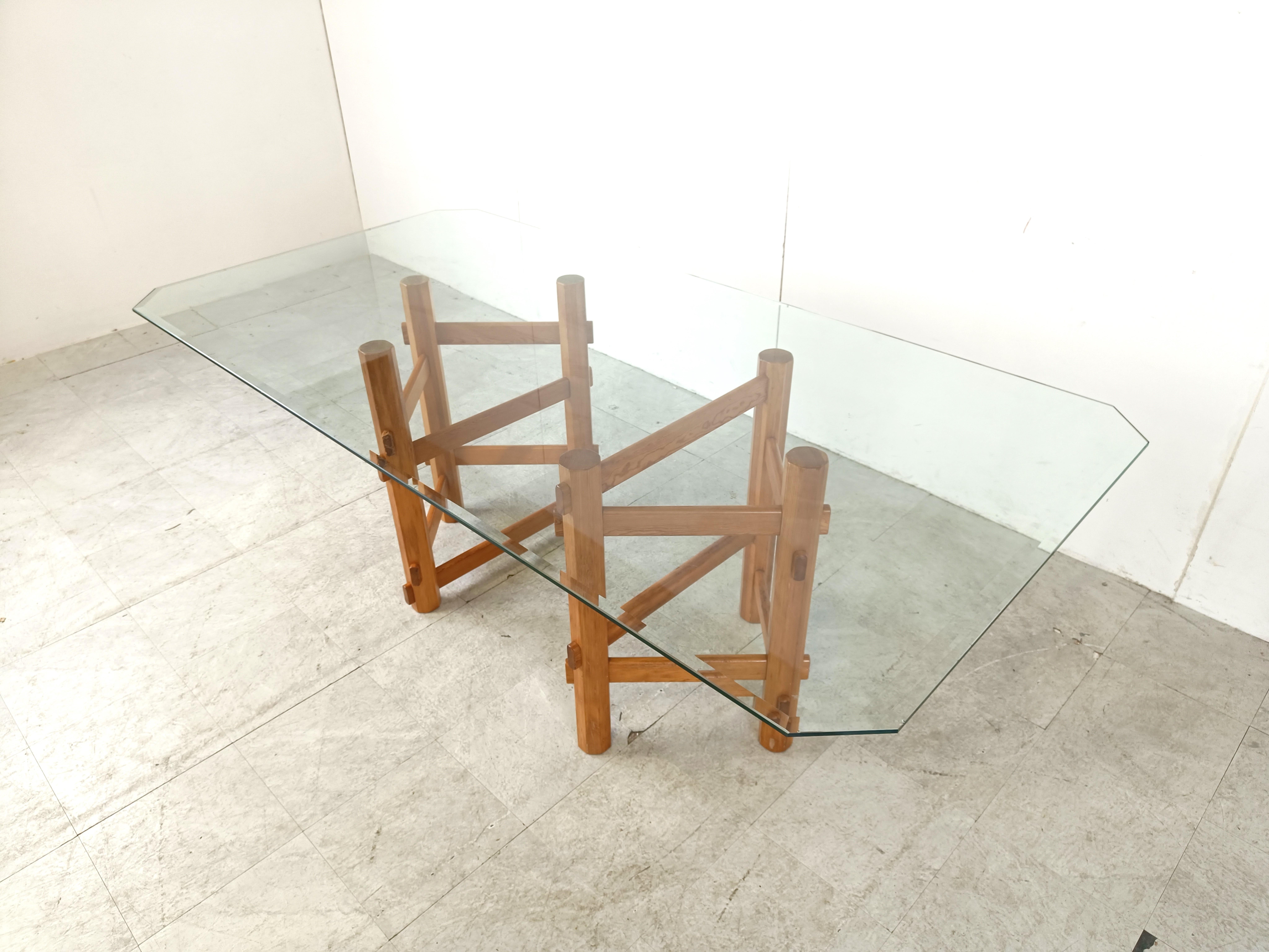 Elegant vintage dining table consisting out of a glass beveled table top and two wooden bases with interlocking structures.

Timeless design.

1980s - Belgium

The wooden bases have some wear as pictured but still look great

Dimensions:
Height: