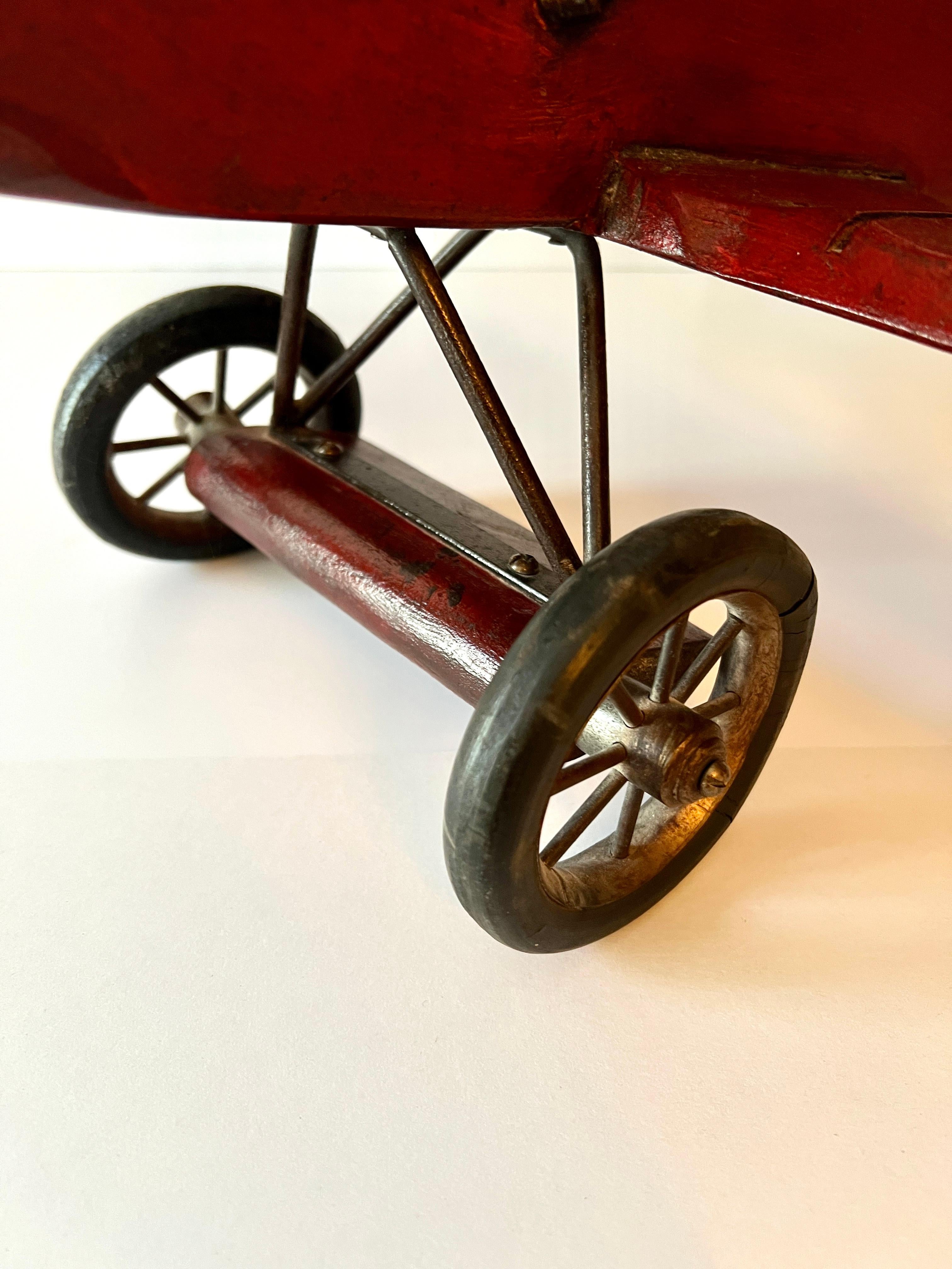 20th Century Wooden Biplane with Rubber Wheels, Metal Propeller  and Pilot