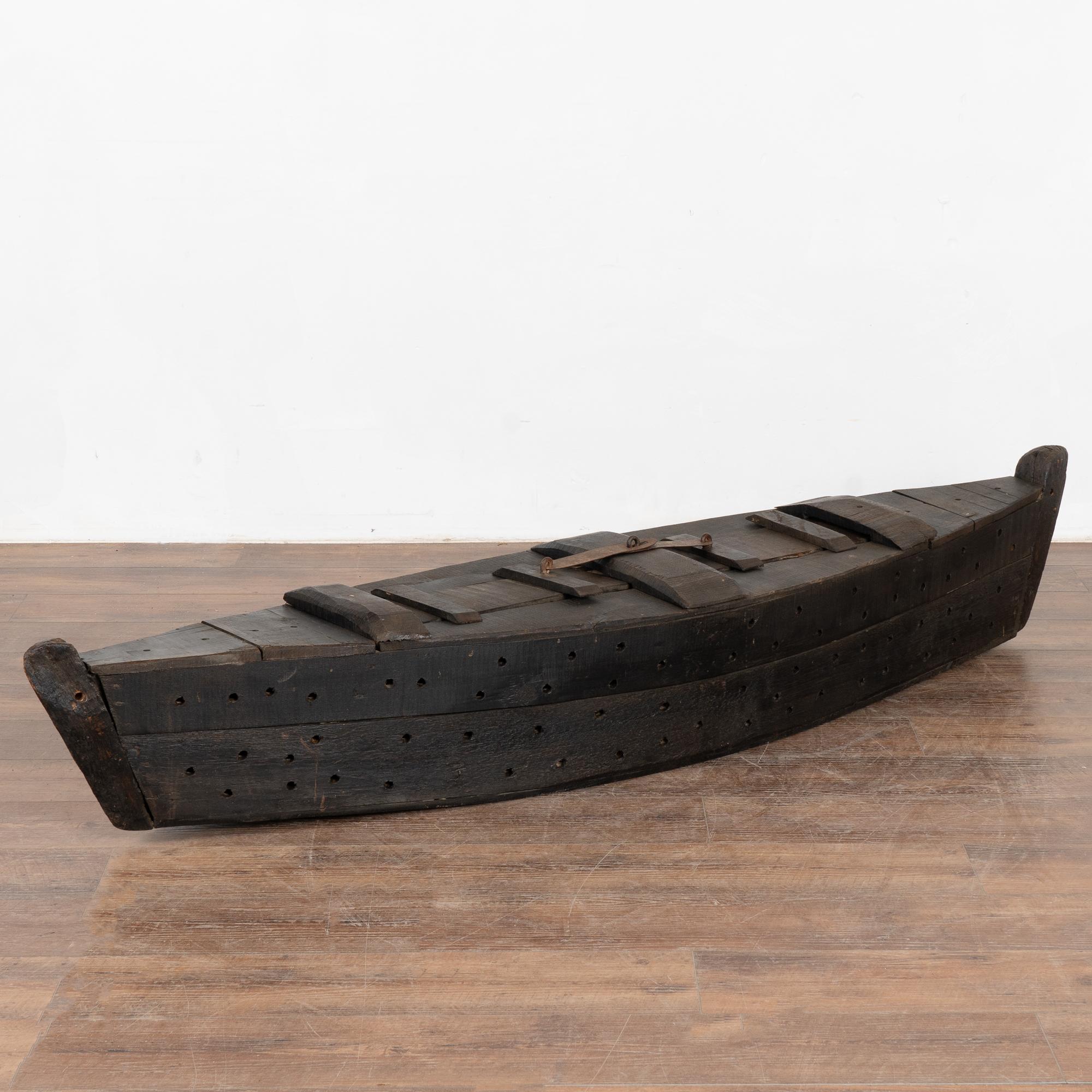 The many holes in this large 6.5' model boat served a specific purpose; it was used while fishing as a type of oversized creel to keep fish alive. The large size makes it a unique decorative statement piece perfect for a home near water.
Note the