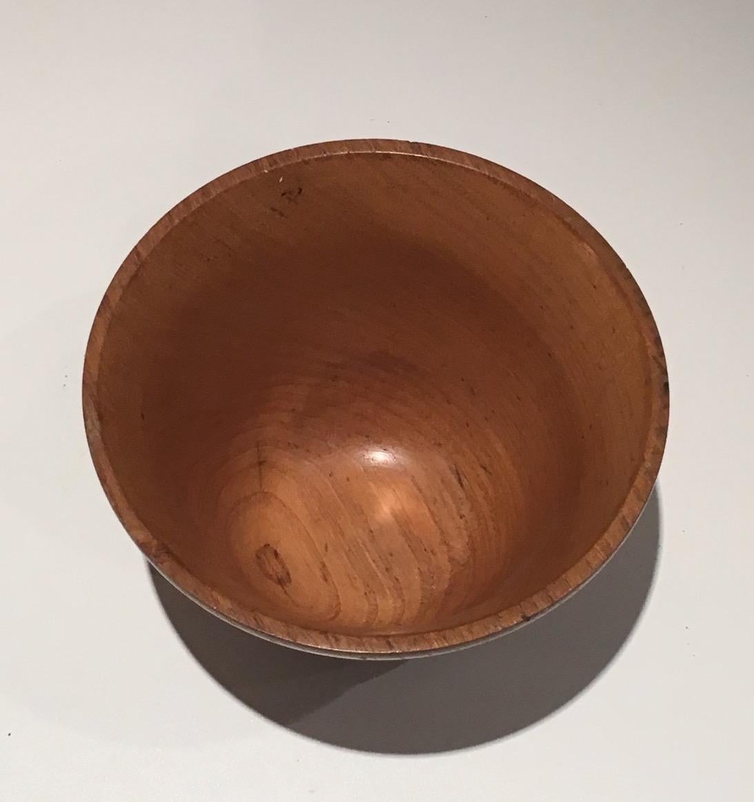 This small bowl is made of wood. It is stamped in the paste. Circa 1970