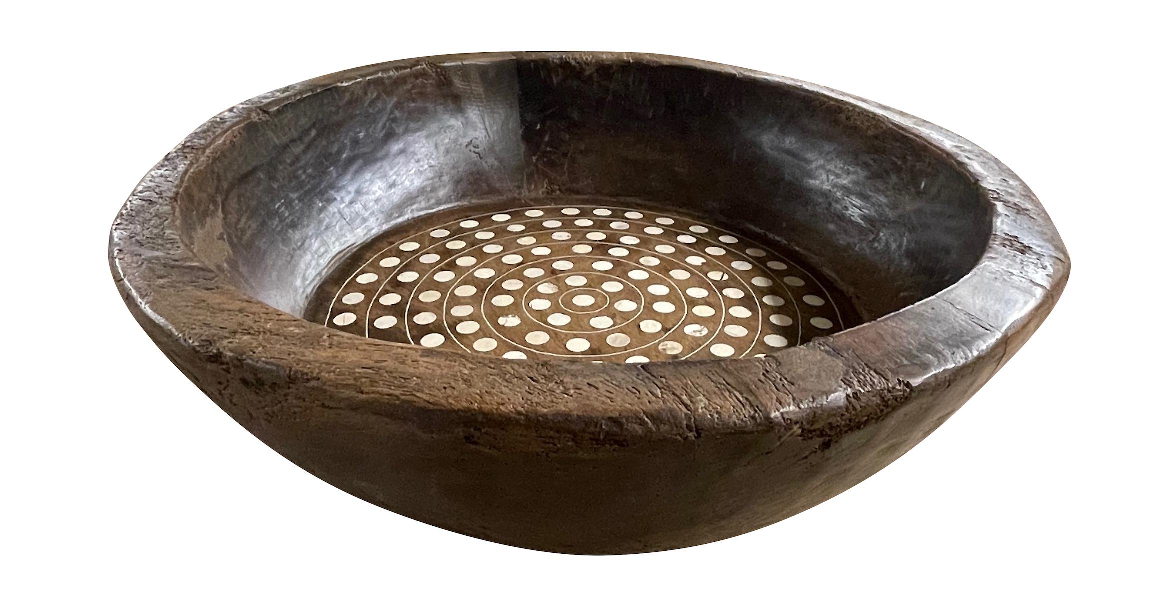 Contemporary Indian round wood bowl with round bone inlay.
