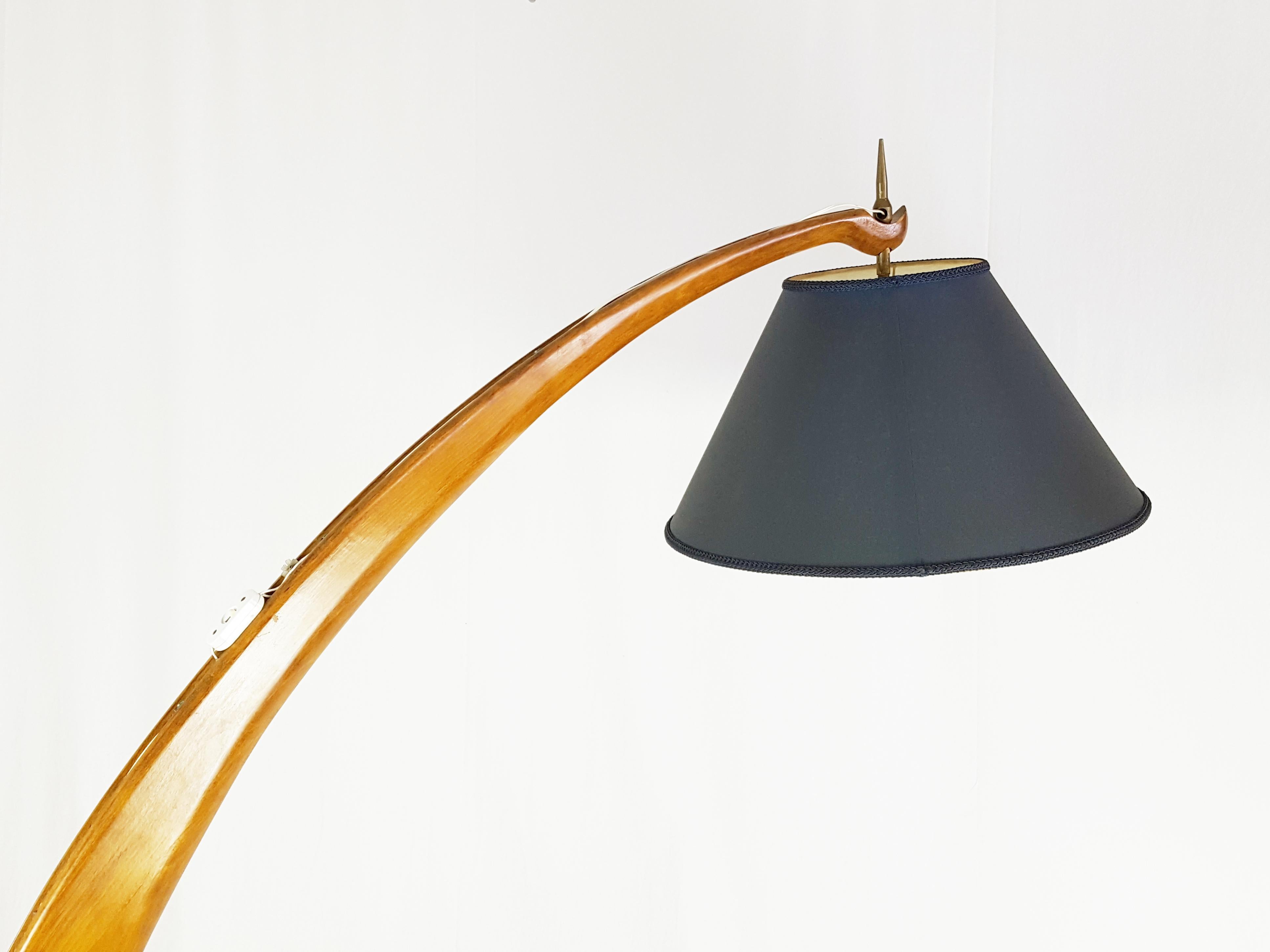 Sculptural wooden structure with brass lamp holder and blue navy fabric shade. This floor lamp was designed and produced in Italy around 1950s. It remains in very good vintage condition: few wood defects on the base as showed in pictures. The fabric