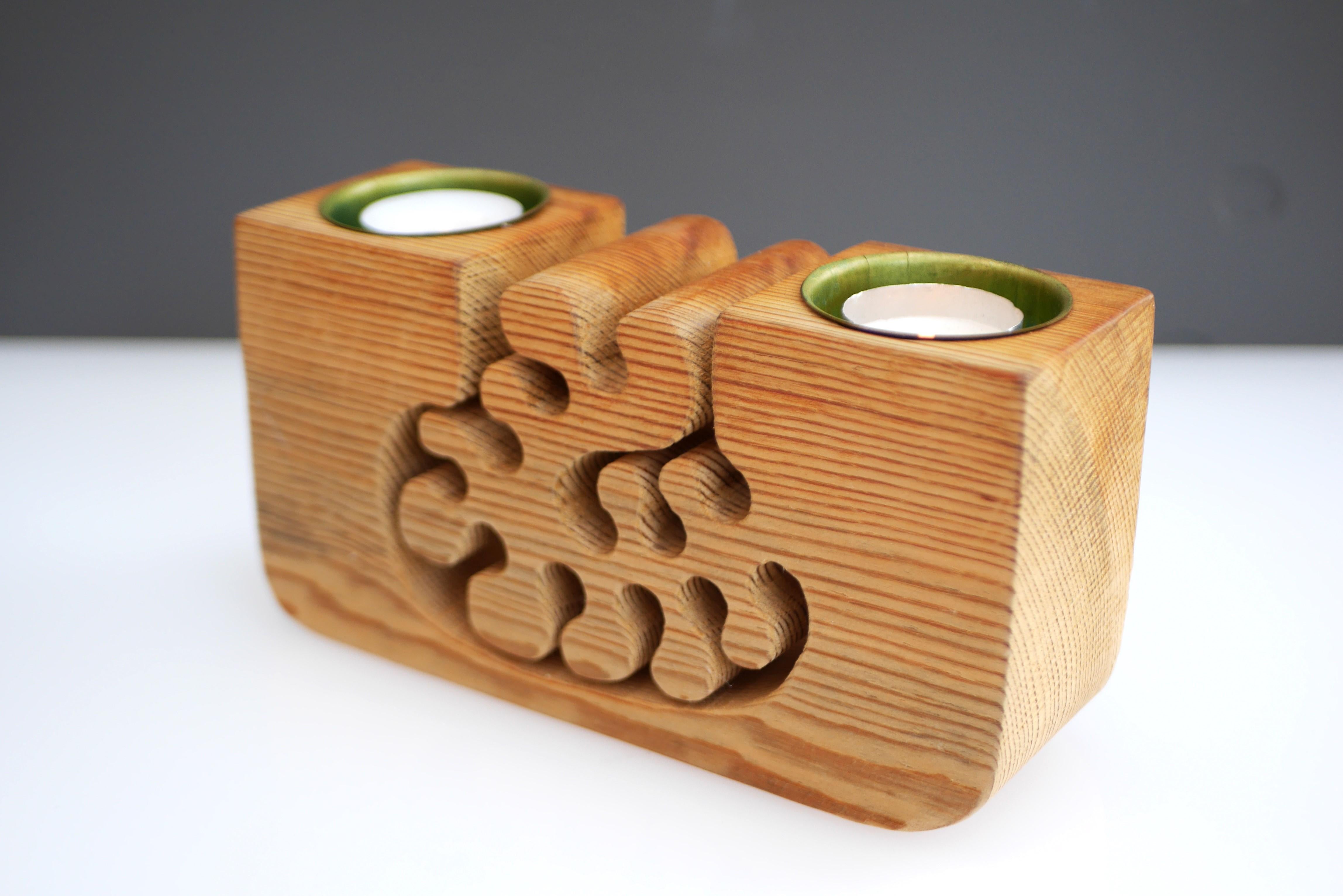 An unusual and rather rare Swedish Mid-century modern handmade candleholder, which is also a figurative abstract sculpture. It is made out of one solid piece of wood with intricate and organic shapes, with the possibility of holding two candle
