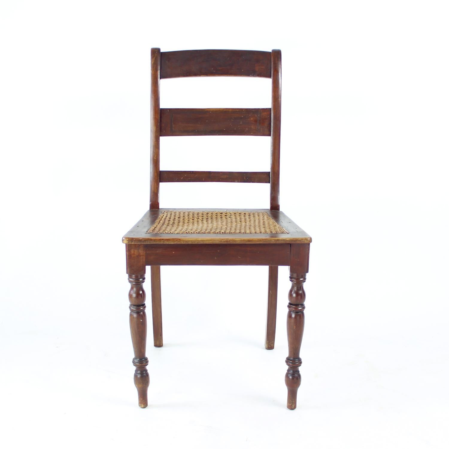 This beautifully crafted vintage chair, produced in Czechoslovakia in the 1910s, is a striking example of early 20th-century European design. Made from solid oak, the chair features a delicately woven cane seat and intricate detailing that reflect