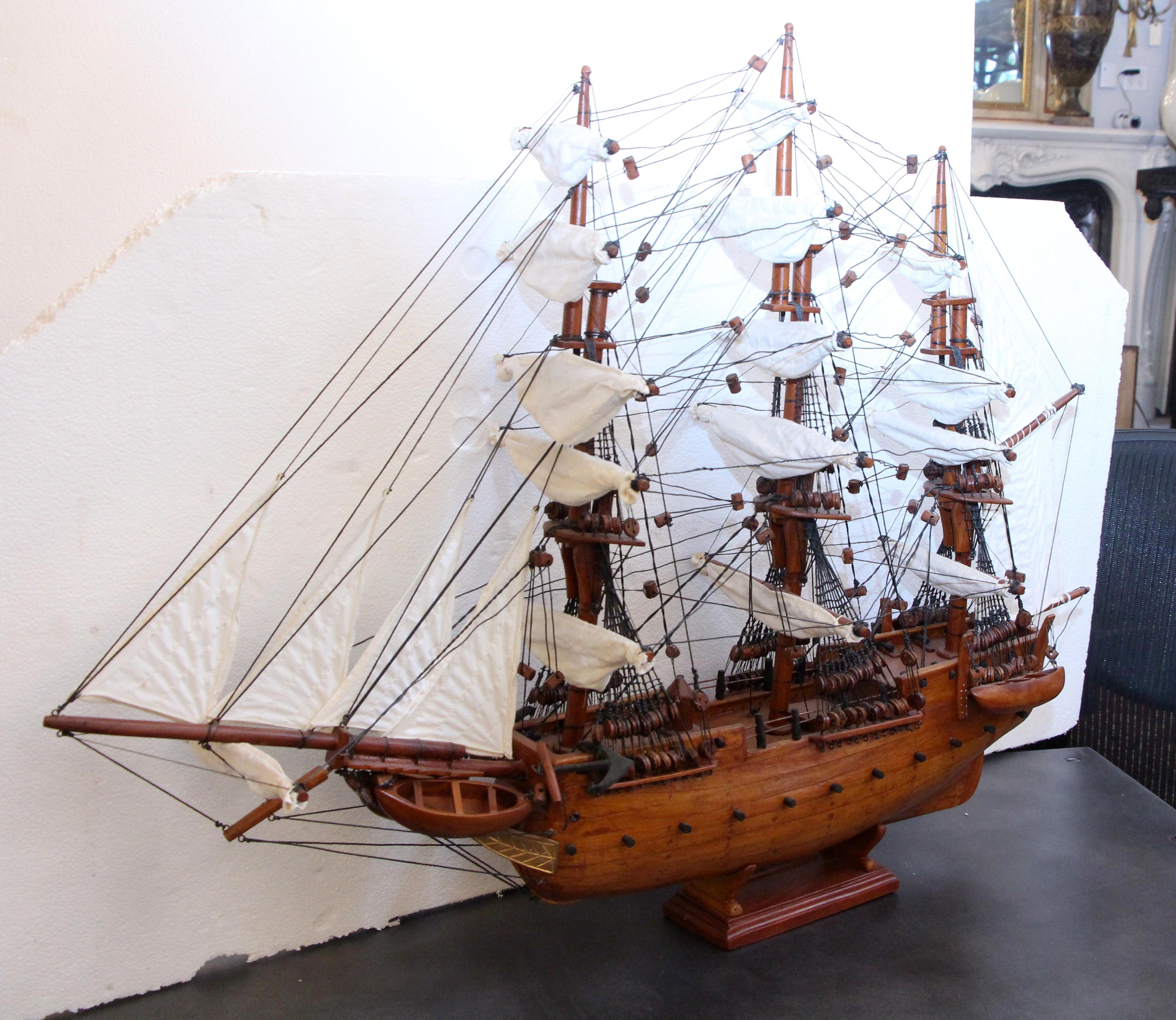 Model ship made by hand of wood and canvas, stamped Constitution. This was intricately done by local craftsmen in Haiti. This can be seen at our 2420 Broadway location on the upper west side in Manhattan.