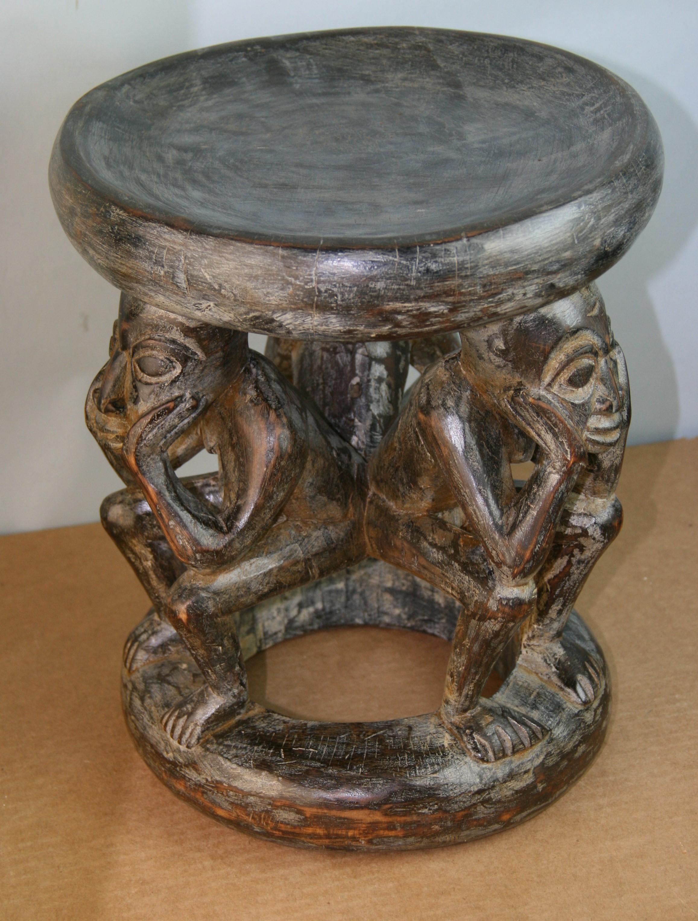 Wooden carved Akan stool with figural group.