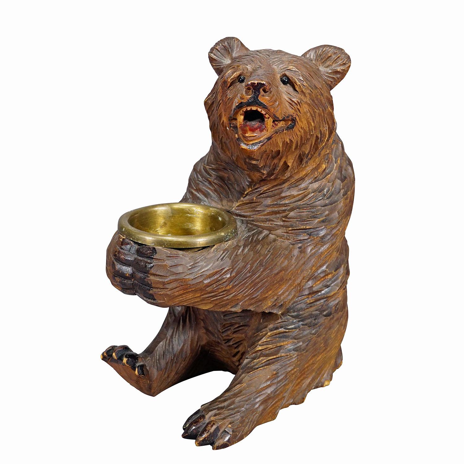 Wooden Carved Black Forest Bear with Brass Bowl, Brienz 1920s
Item e7270
An antique statue of a sitting bear holding a small bowl made of brass. Made of lindenwood, finely handcarved with naturalistic details in Brienz, Switzerland ca. 1920s. A nice