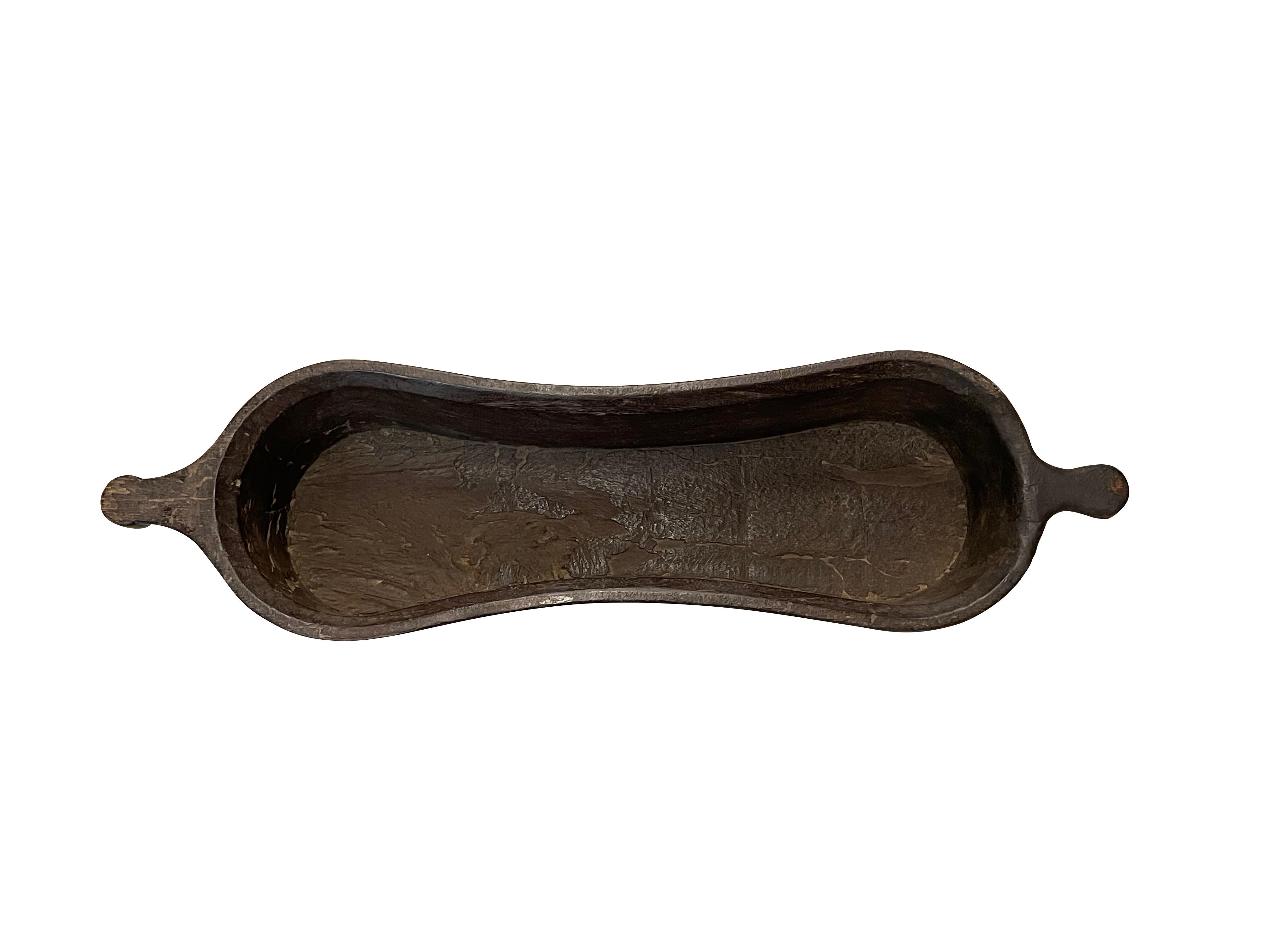 19th century Indonesian large carved wooden bowl with hour glass shape.
Two handles.
Used for transporting and serving food.
