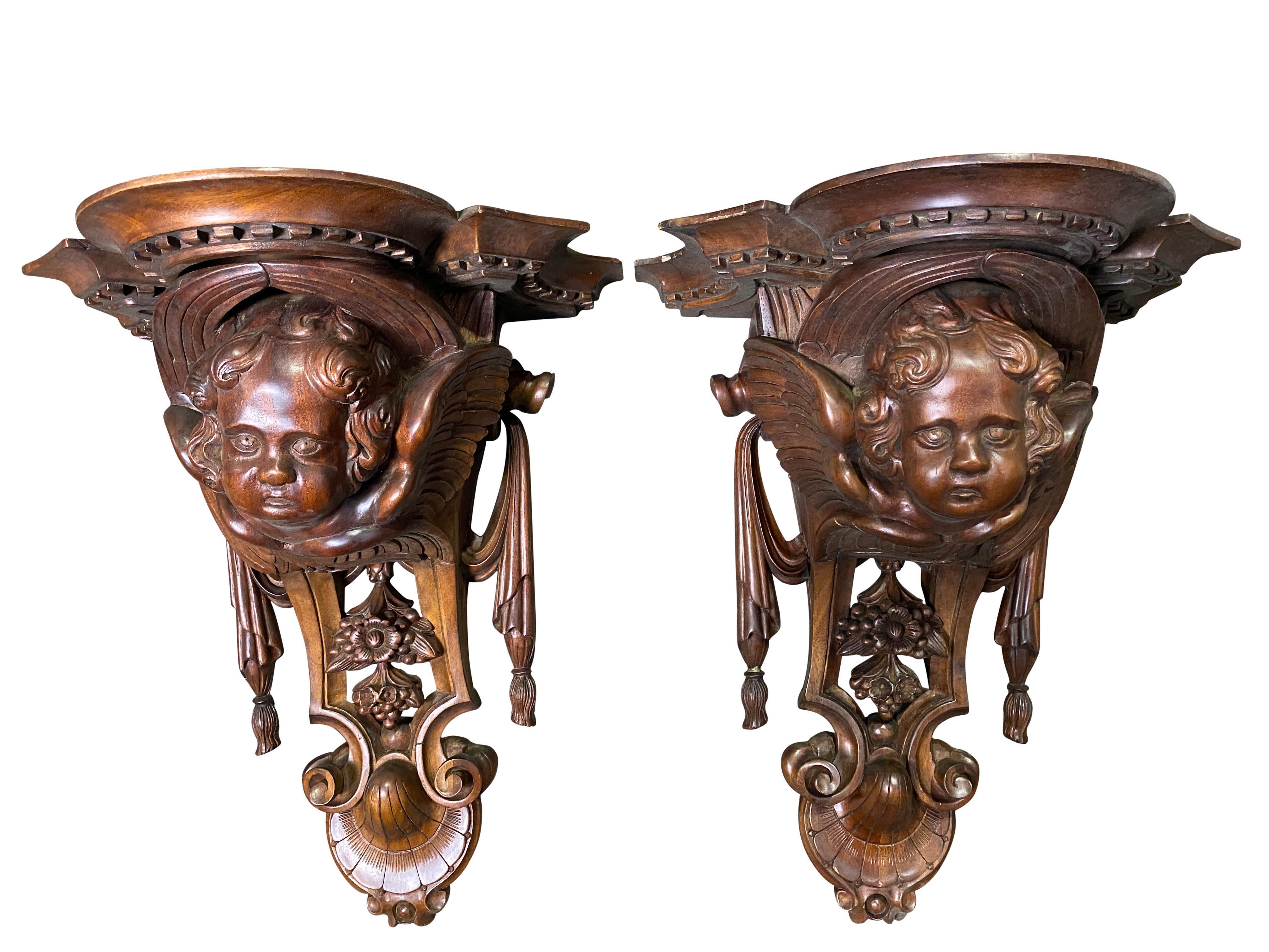 Two excellently carved wooden wall sconces with carved cherub faces and flowers with seeds. The level of symmetrical patterns makes these pieces very aesthetic.

Dimensions: (cm)
H 55/W 40/D 30.