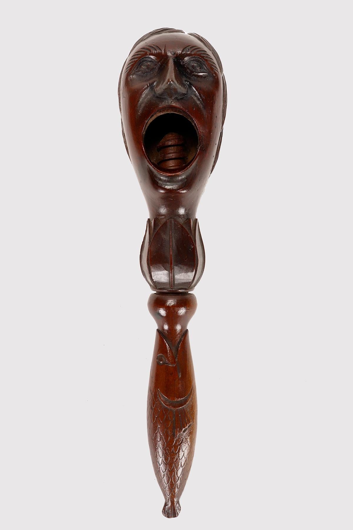Made out of hazel wood, the nutcracker simply depicts a screaming man’s head. The handle depicts a fish. The subject is really unusual, the quality of sculpting, carving and cure of each detail, original patina. France circa 1880. 