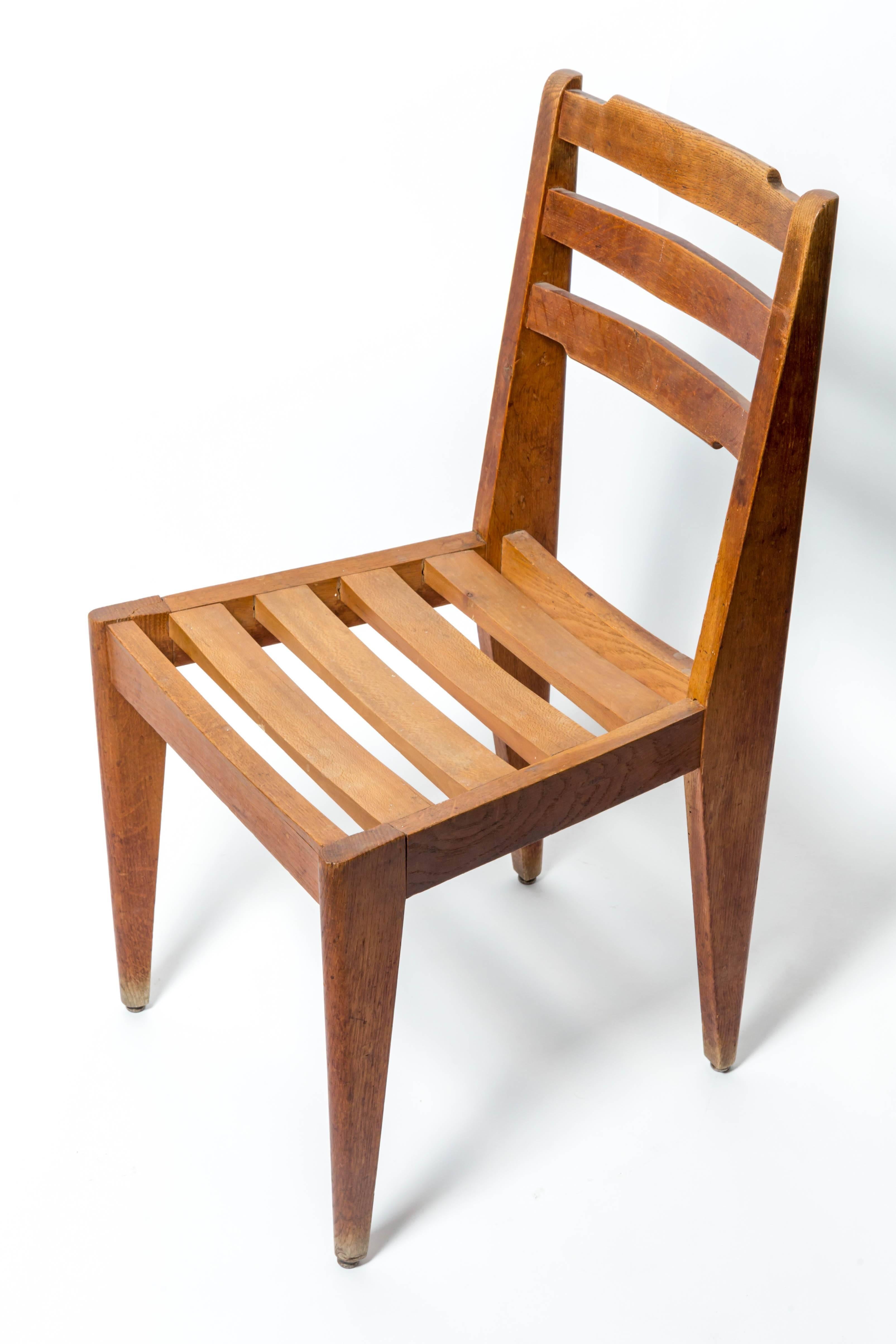Wooden chair attributed to Gustave Gautier, France, c. 1950s. 

Handsome design consists of a solid hardwood construction, tapered legs, and slatted seat and backrest. 

The chair has been lightly refurbished to ensure structural stability while
