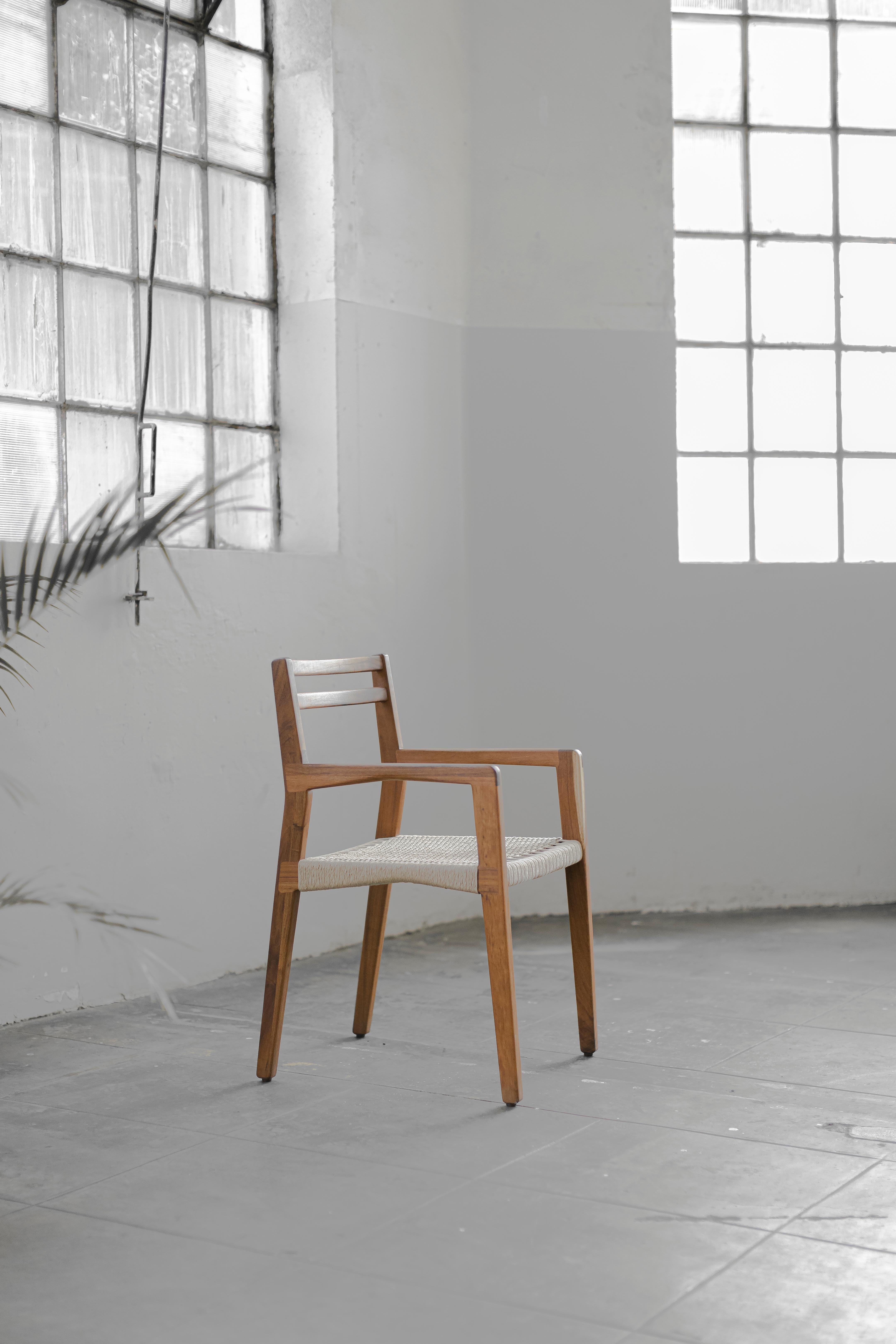 Wooden chair C Collection with armrest made with oak or tzalam wood and woven with paperboard, jute or piola.
