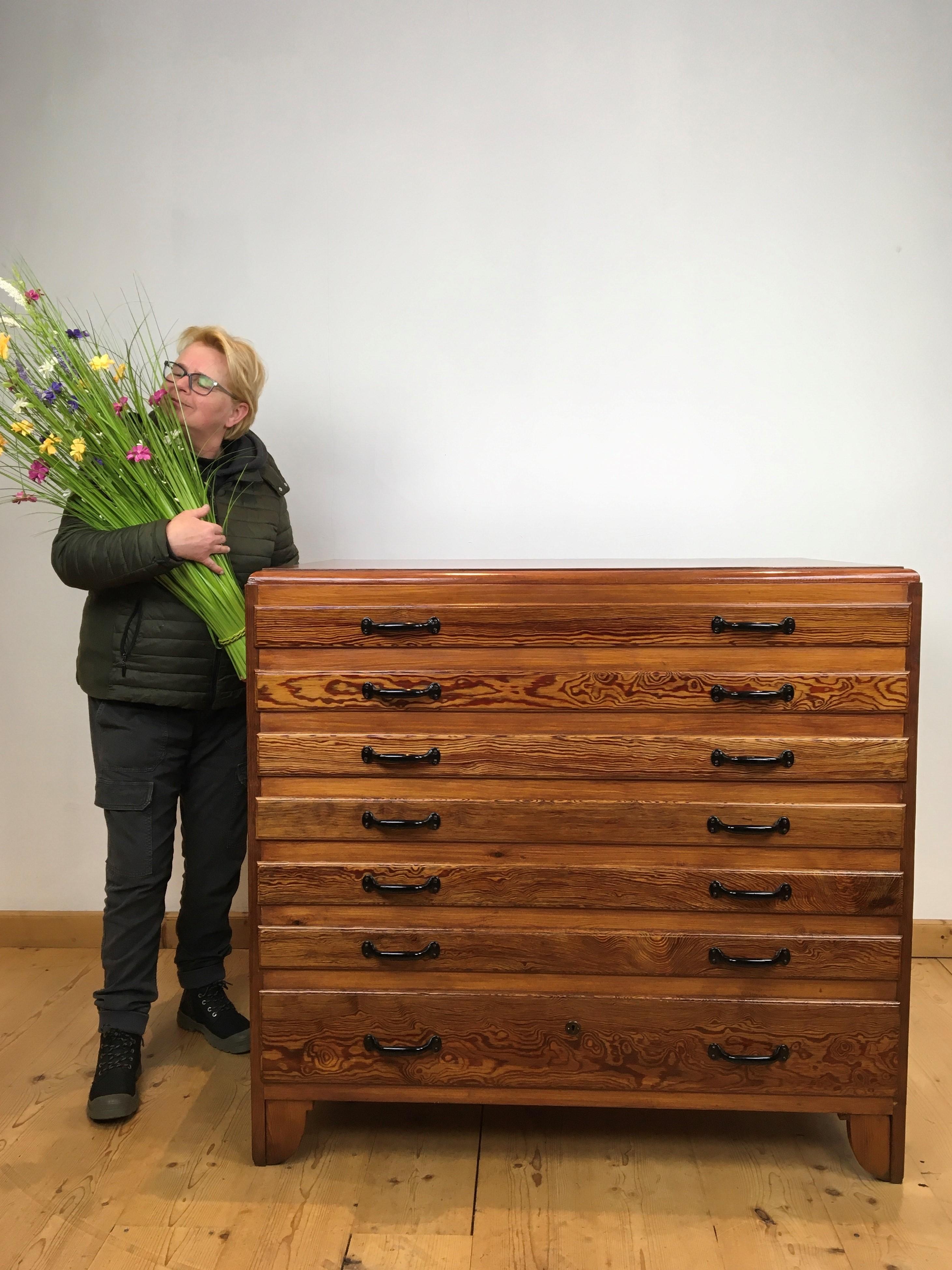 Great looking large wooden chest of drawers with 7 drawers or architect's file cabinet. 
A storage cabinet with 6 drawers and under 1 larger drawer. 
Each drawer has 2 black metal handles. 
It's great storage for many type of objects. 
In the