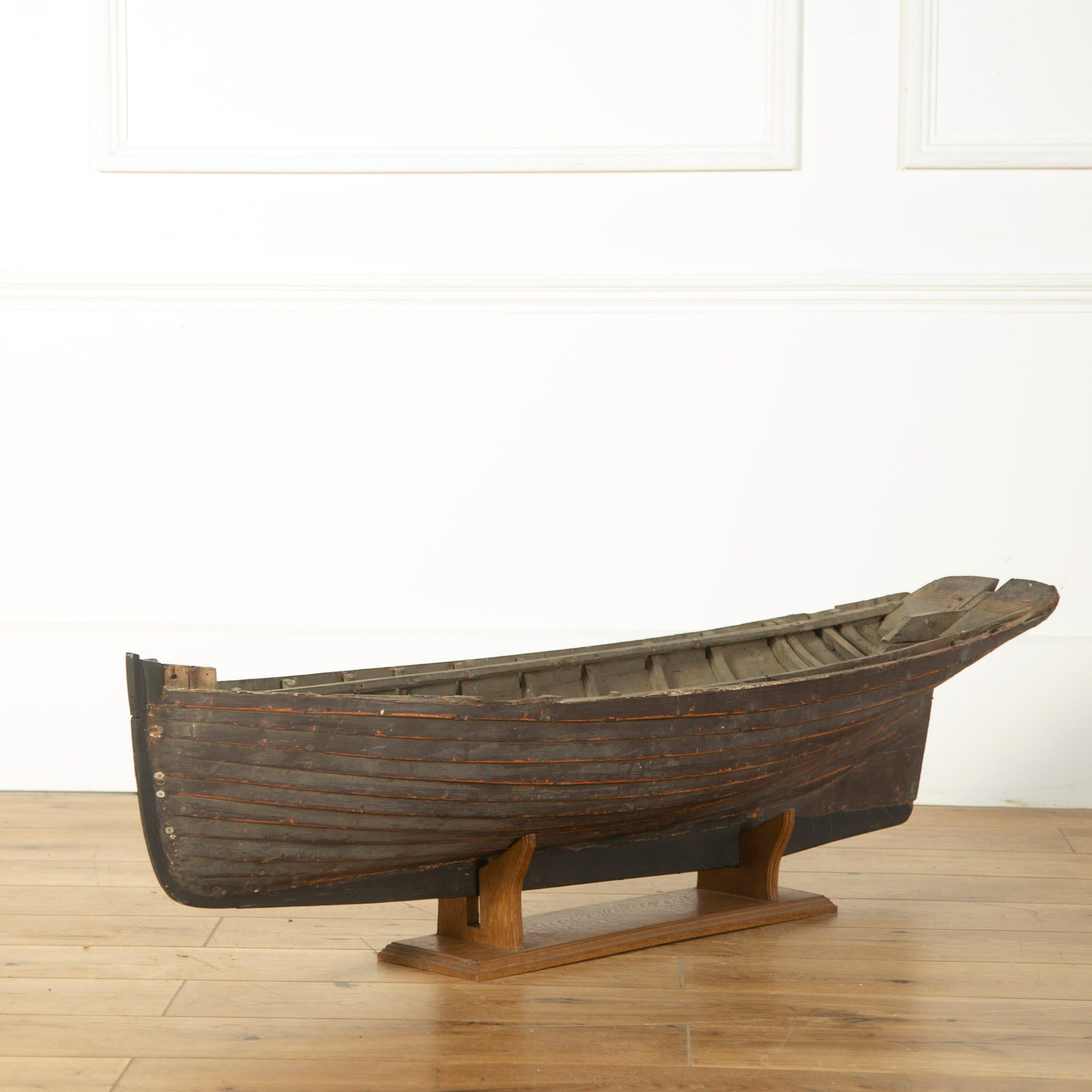 Wooden clinker built boat hull on stand of grand scale, English, circa 1900, in lovely original dry patina.