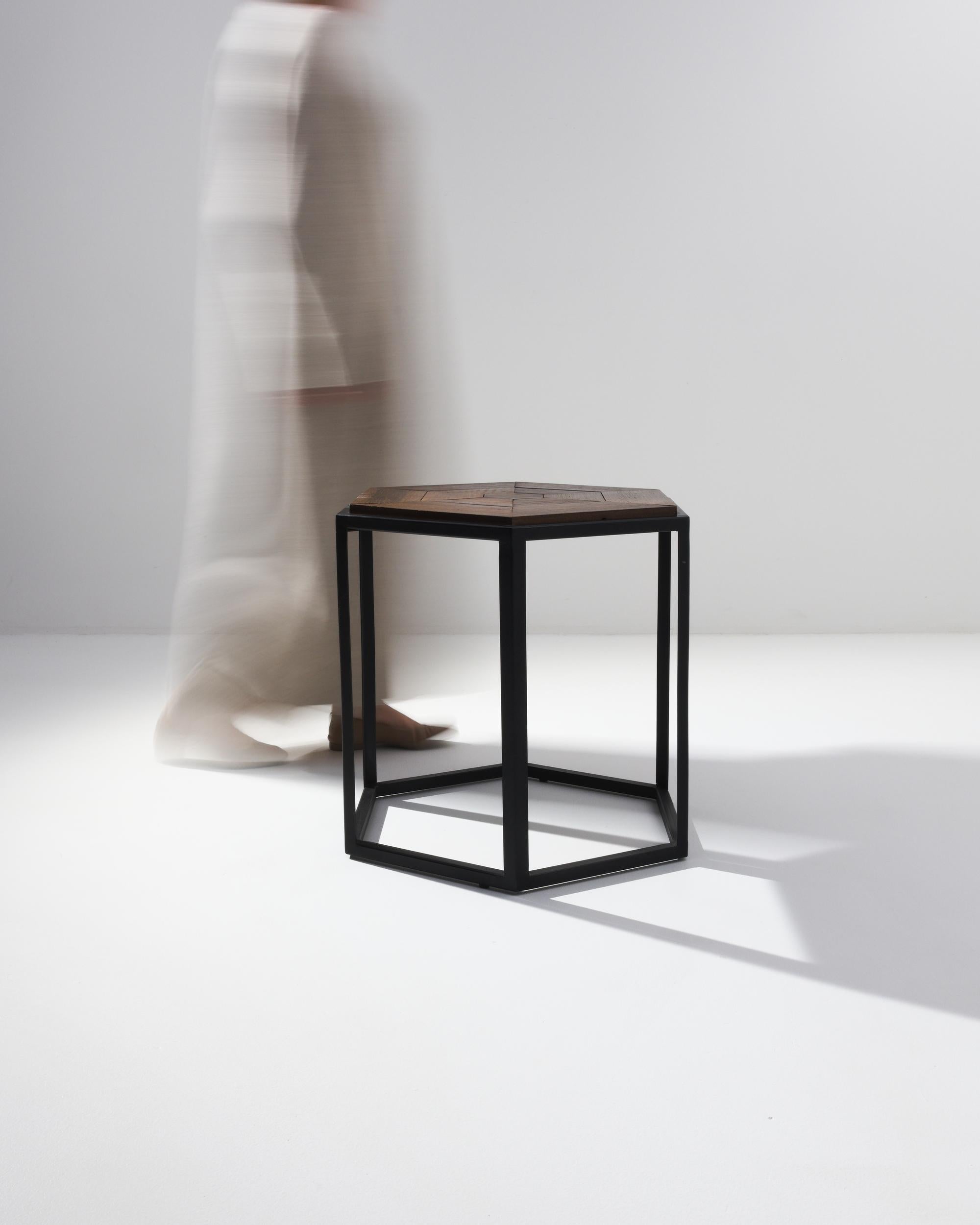 Produced in our atelier as a one of a kind prototype combining a minimal steel mount with a parquet style azobé wood top. This coffee table boasts a visually striking metal base crafted in the shape of a cylindrical polygon, which harmoniously pairs